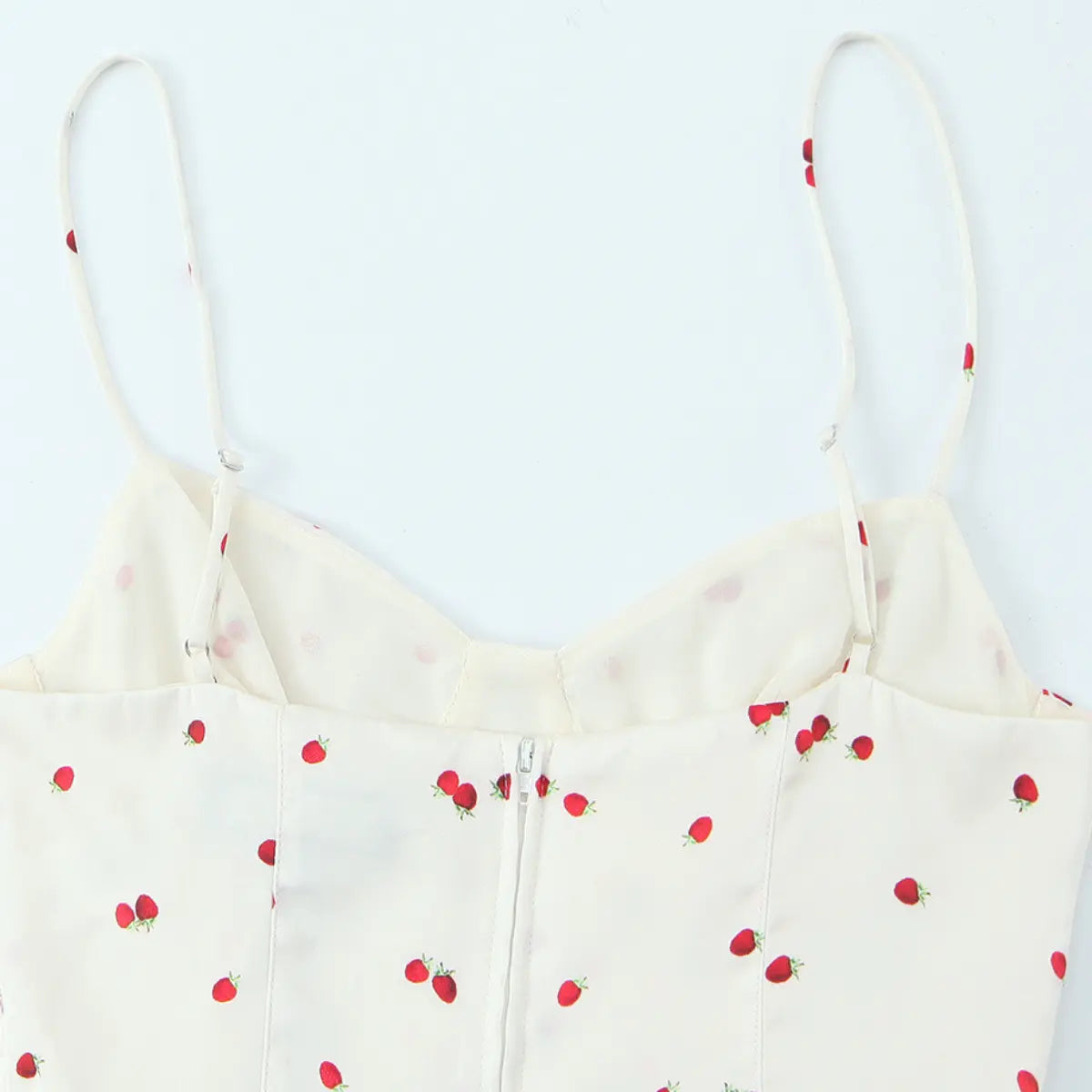  Back view of the cream strawberry print cami top, showing the center zipper, adjustable straps, and vertical boning seams