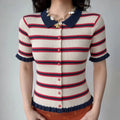 Front lifestyle shot on model, navy polo collar striped knit cardigan, full front button design, ruffled sleeve and hem, matched with shell starfish necklace and orange bottoms, casual retro summer outfit