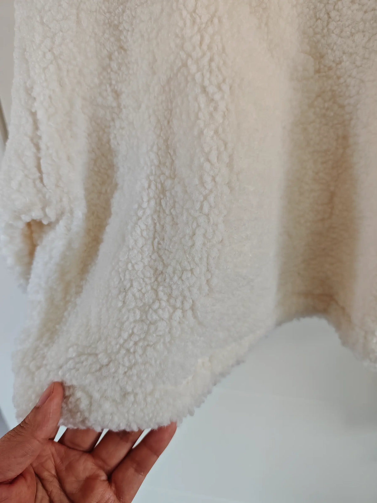 Close-up of cropped hem and teddy fleece texture