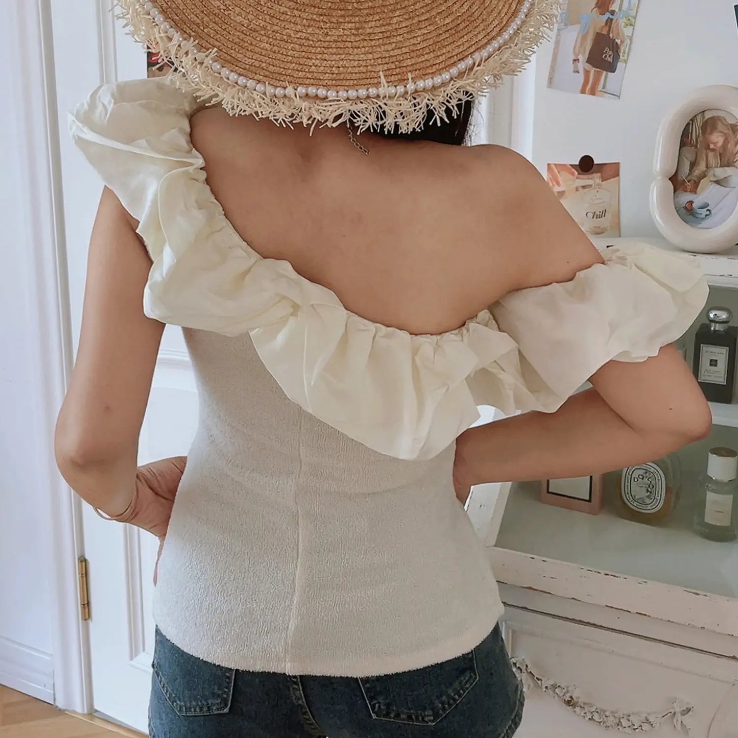 Cream textured knit one shoulder crop top back view detail, wrap-around chiffon ruffle and center back seamed fitted silhouette