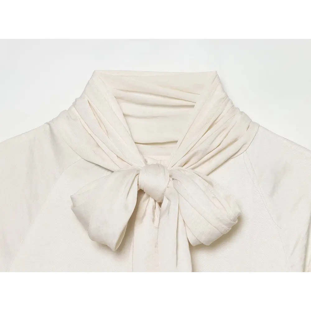 Close-up of self-tie bow knot at neckline