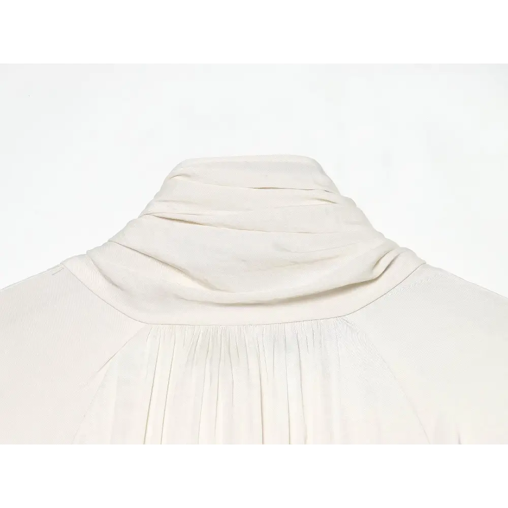 Close-up of draped cowl collar and shirred neckline