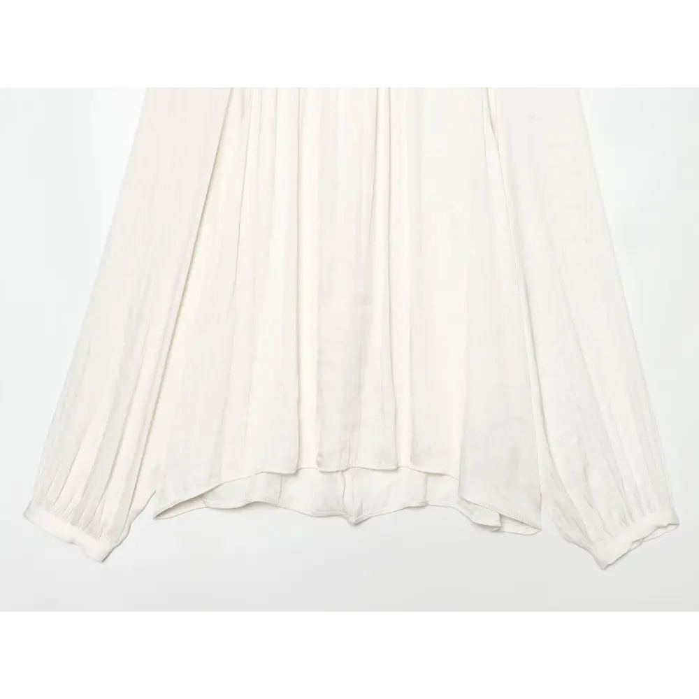 Close-up of flowy draped hem and body