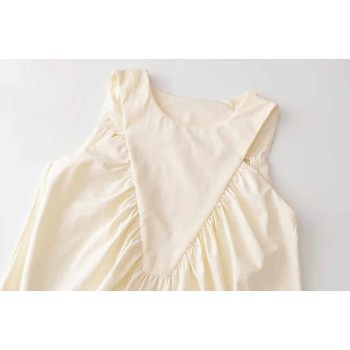 Close-up of round neck and v shape ruched panel
