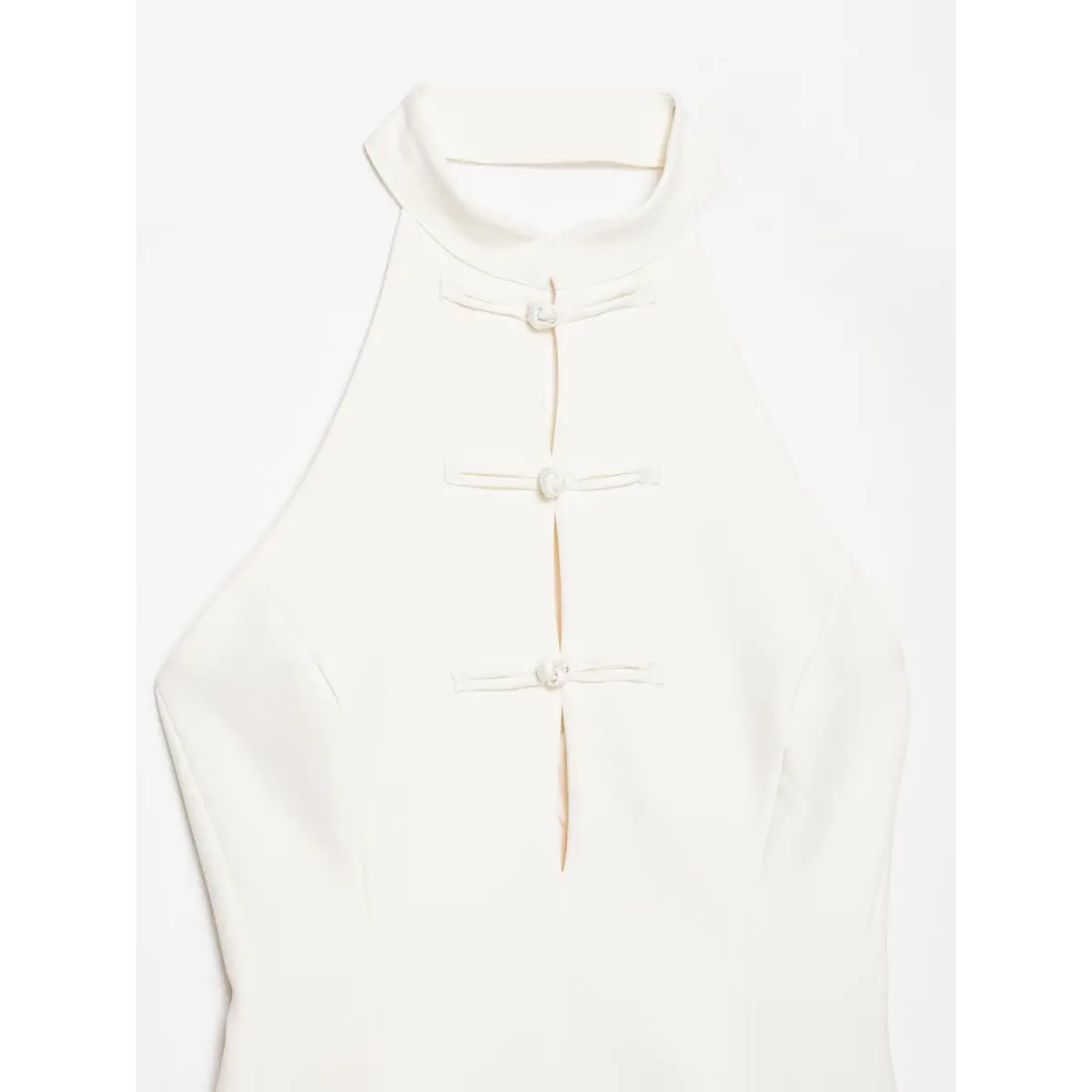 Full front view of a cream-white halter top with traditional Chinese knot buttons and a peplum hem.