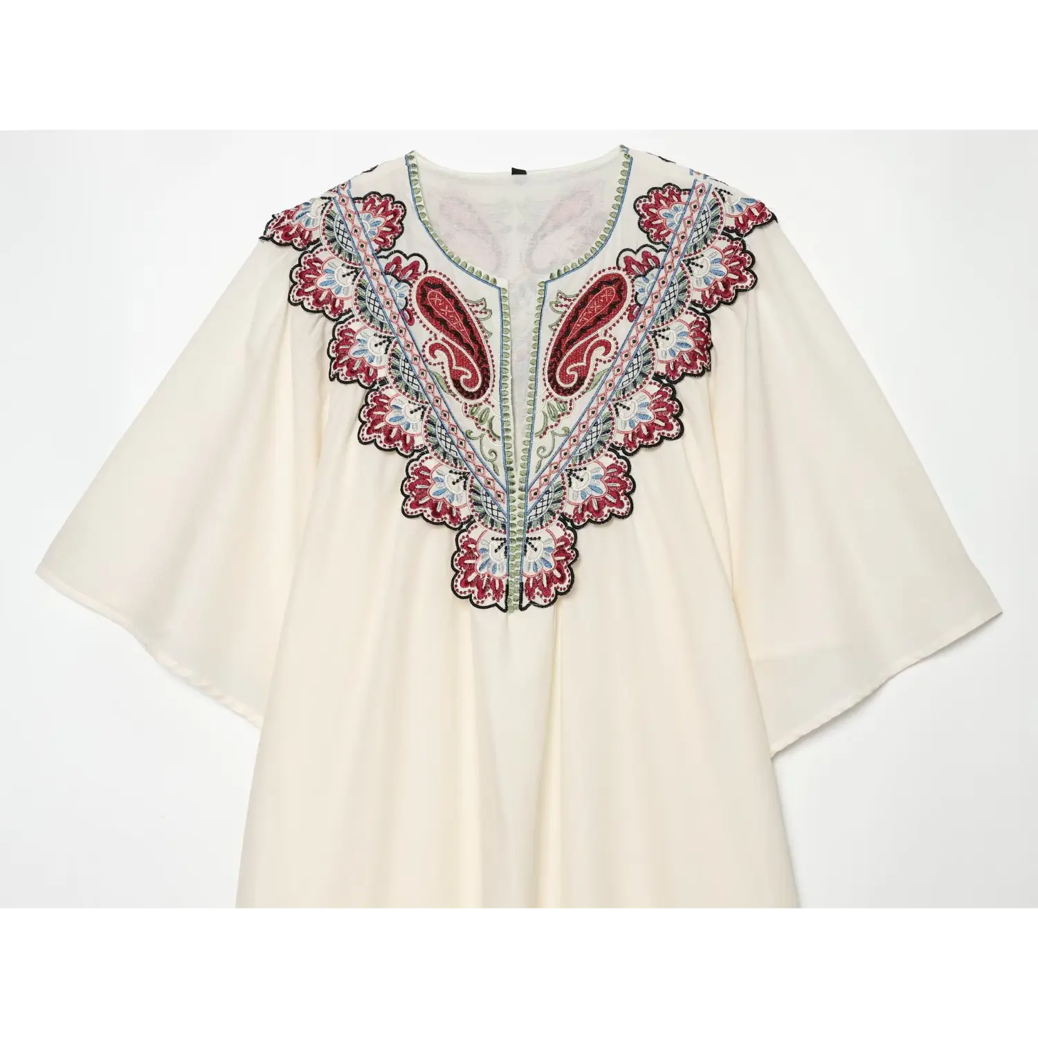 Close-up of front V-neck paisley embroidery on cream white midi dress