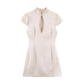 Cream white qipao front main flat shot, mandarin stand collar, single front frog button, hollow keyhole chest cutout
