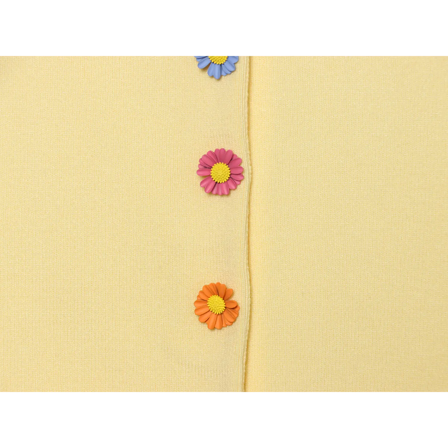 Close-up vertical front placket, 3D dimensional daisy flower buttons in orange, pink, light blue, solid yellow fine knit base