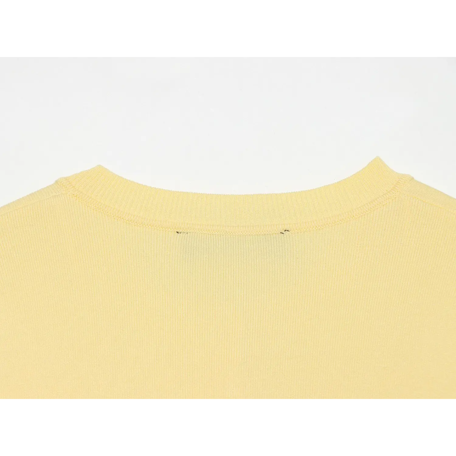 Back neck ribbed trim closeup, neat folded rib knit seam, solid plain yellow back knit panel