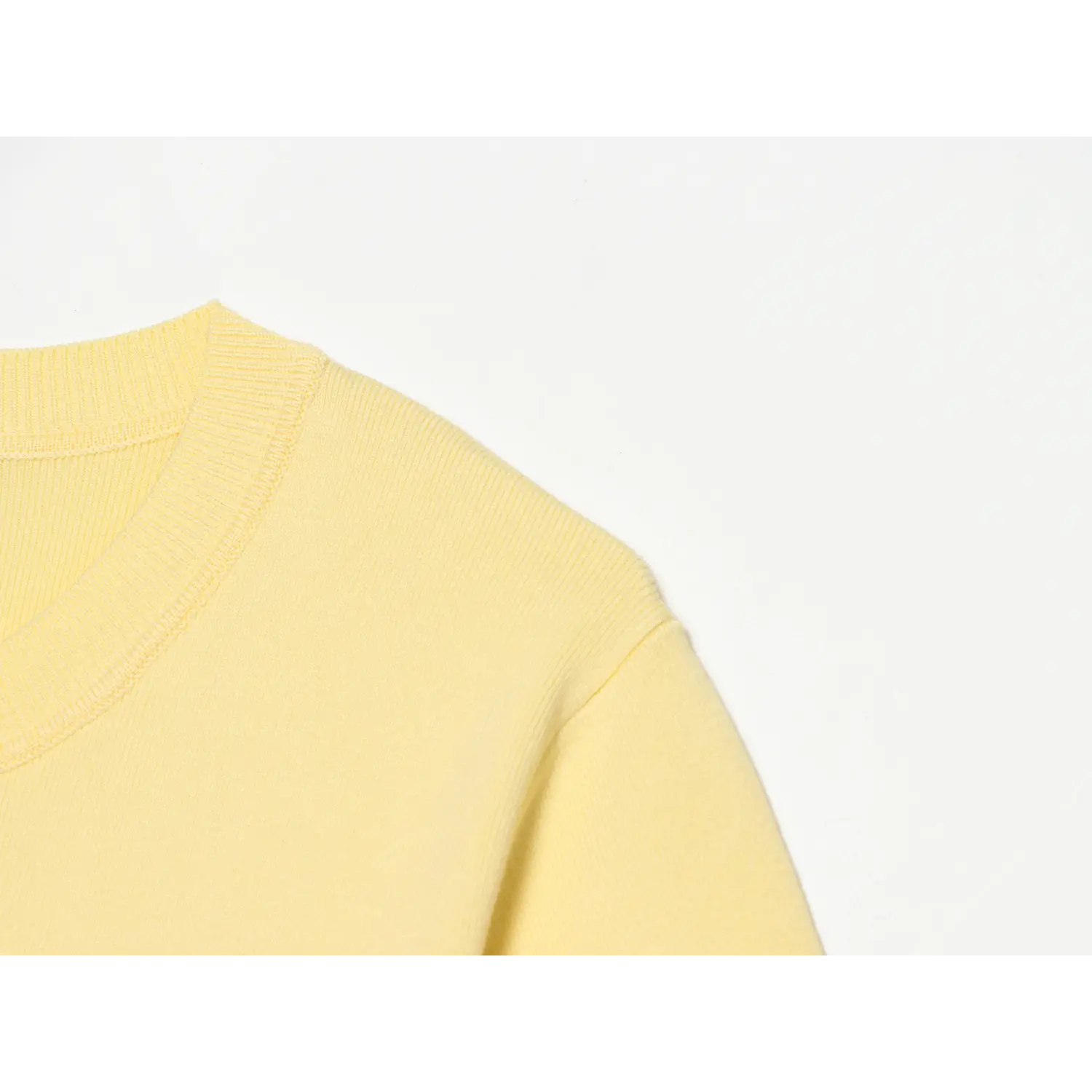 Partial shoulder & rib crew neck detail, tight fine knit texture, solid cream yellow knit, clean rib neck edge