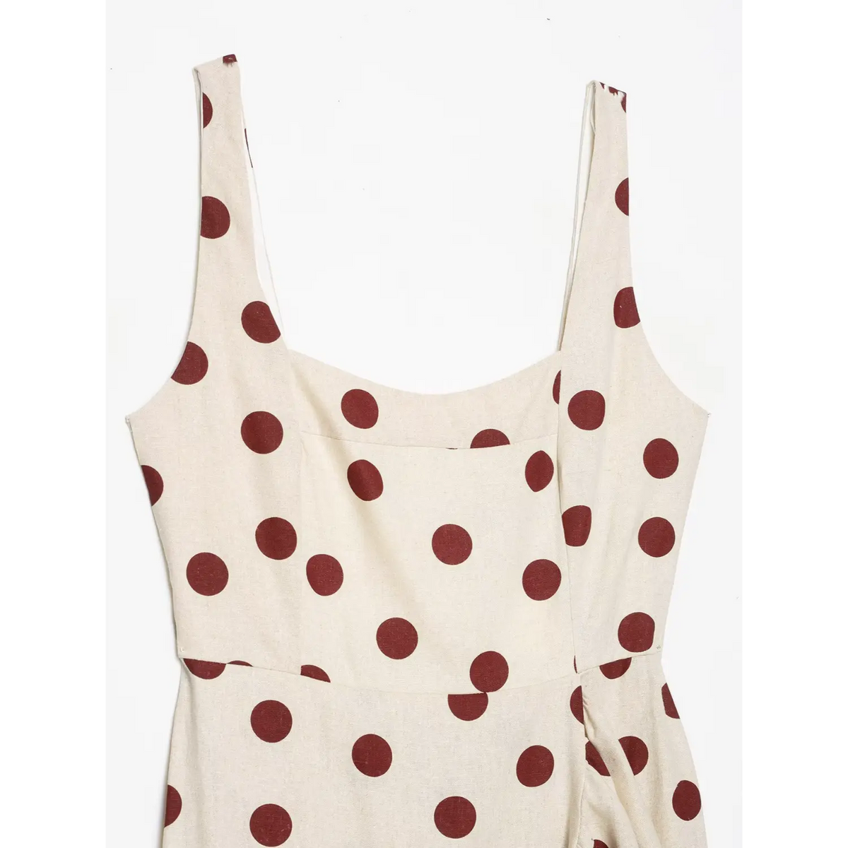 Close‑up of square neckline and wide shoulder straps on polka dot maxi dress