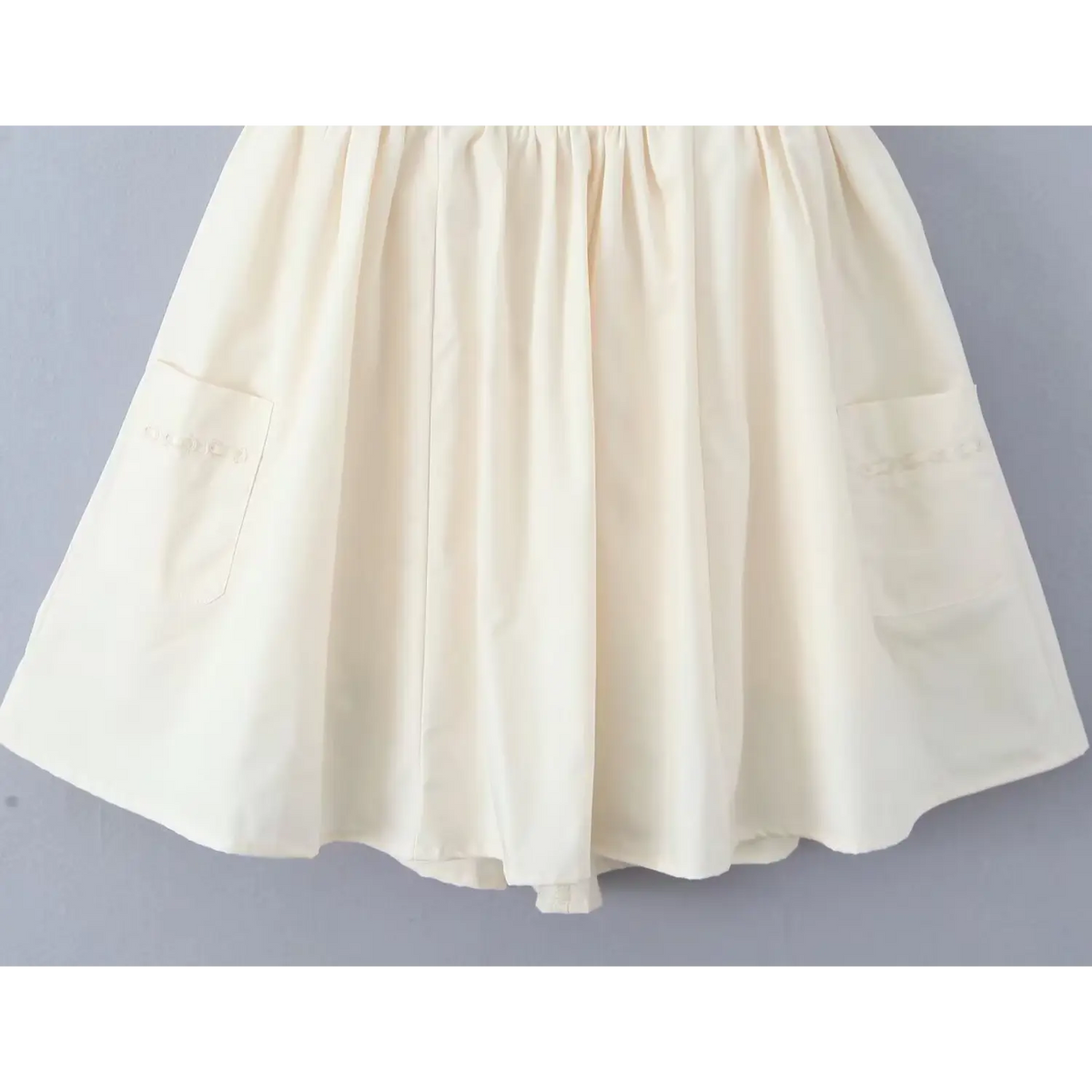 Flat lay view of full flare skirt showing dual side patch pockets