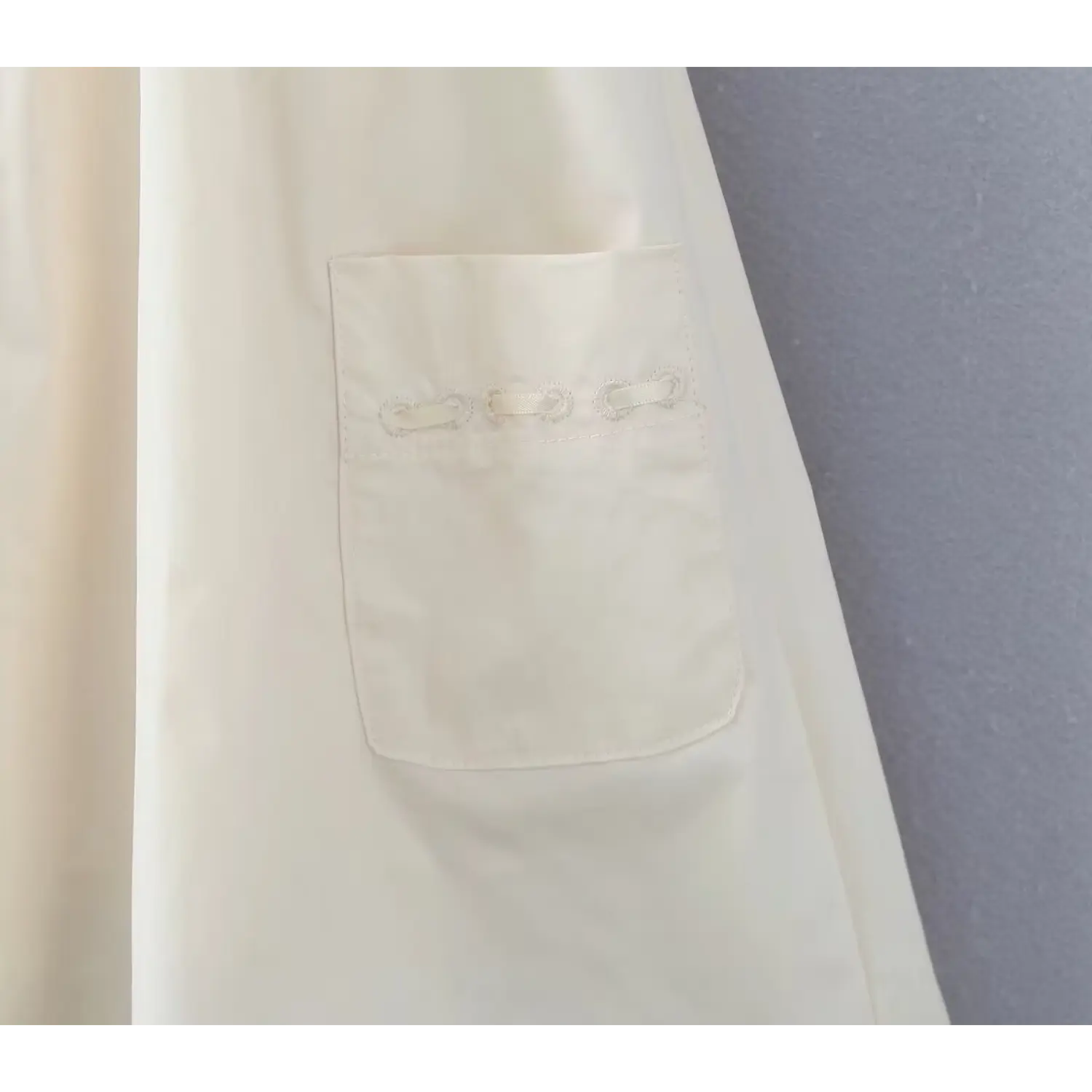 Macro shot of side patch pocket with decorative loop embroidery