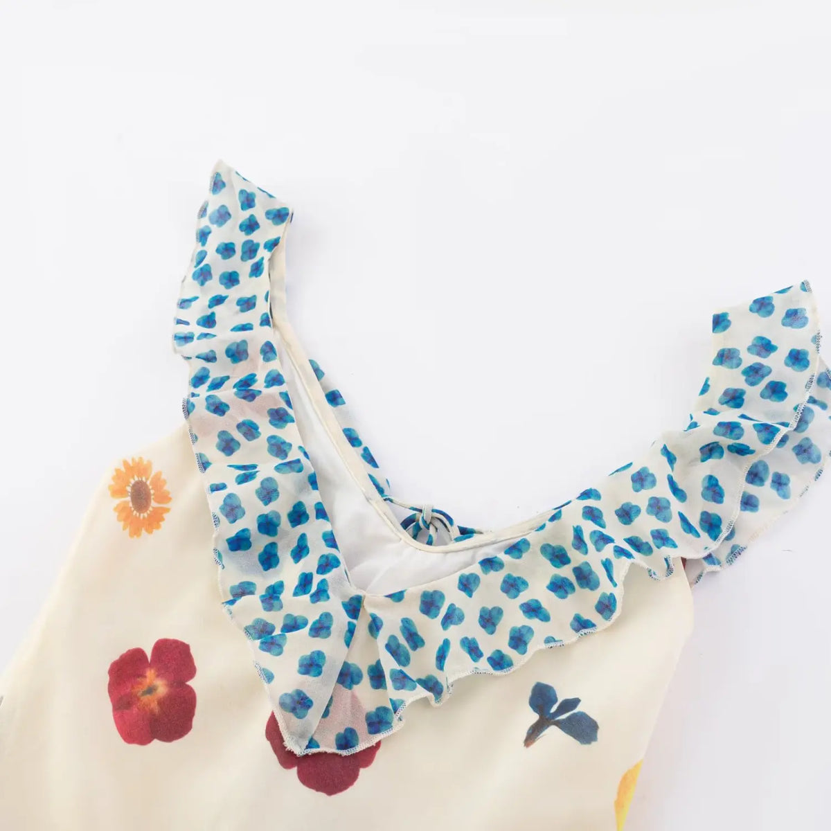 Close‑up of v‑neck ruffle knot front bodice detail