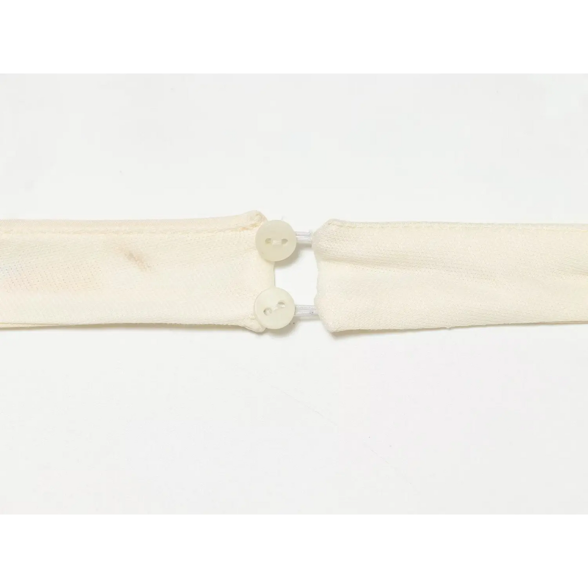 Detail shot of halter neck fabric button closure