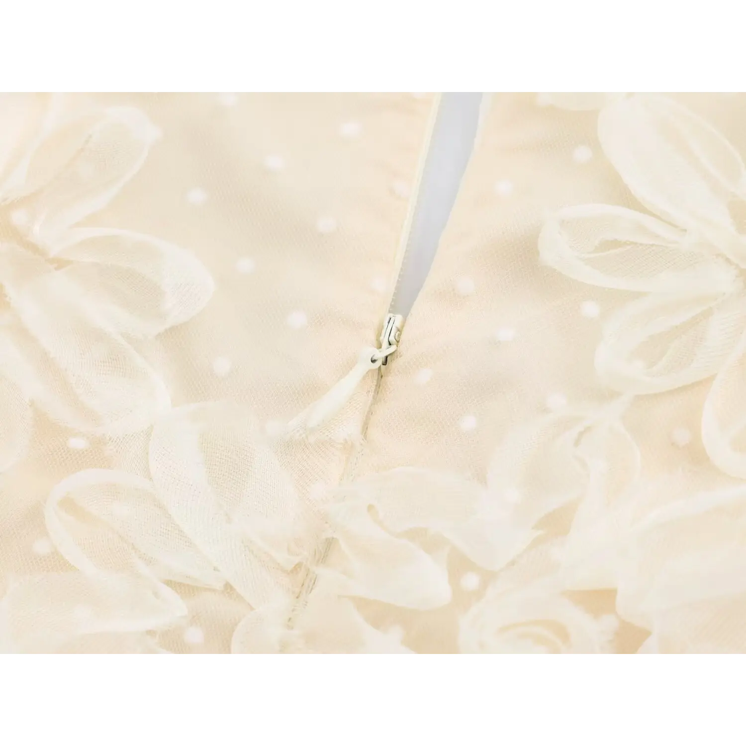 Macro close‑up of invisible back zipper surrounded by 3d flower tulle fabric