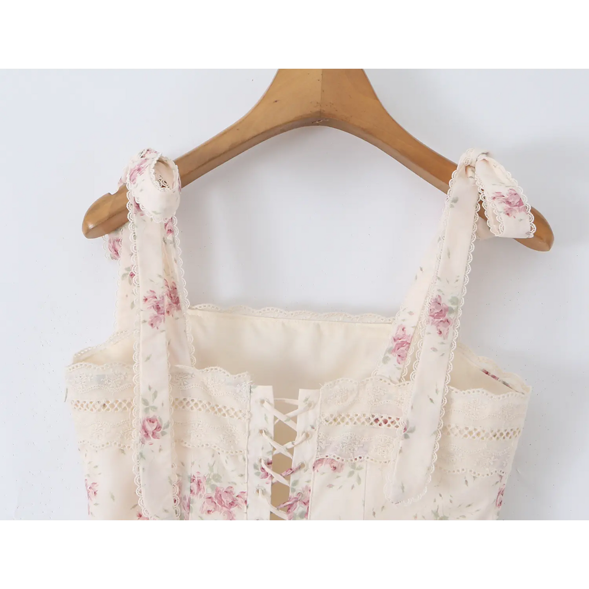 Close‑up of lace‑up corset detail at back bodice of cream floral maxi dress