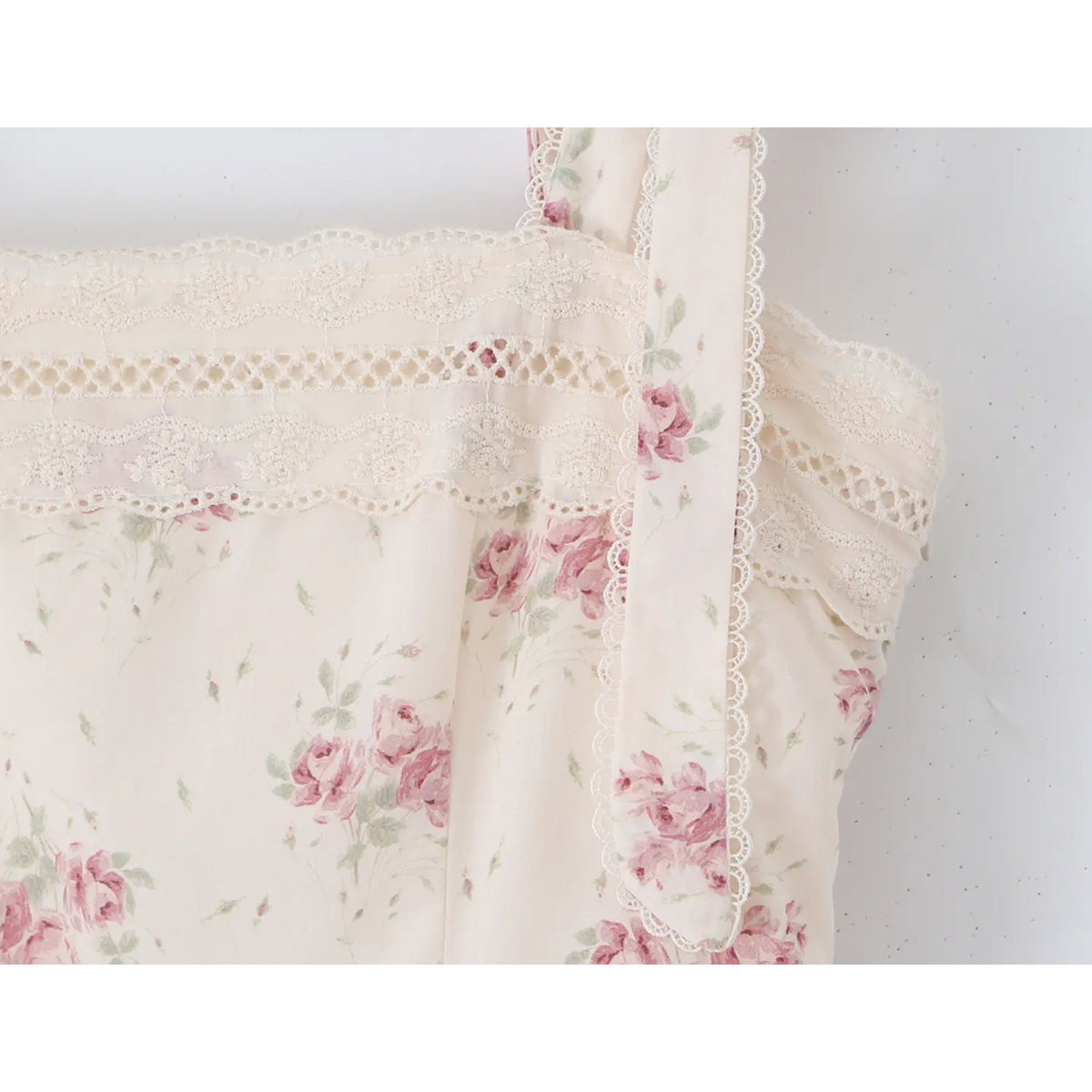 Close‑up of lace trimmed square neckline and tie shoulder straps