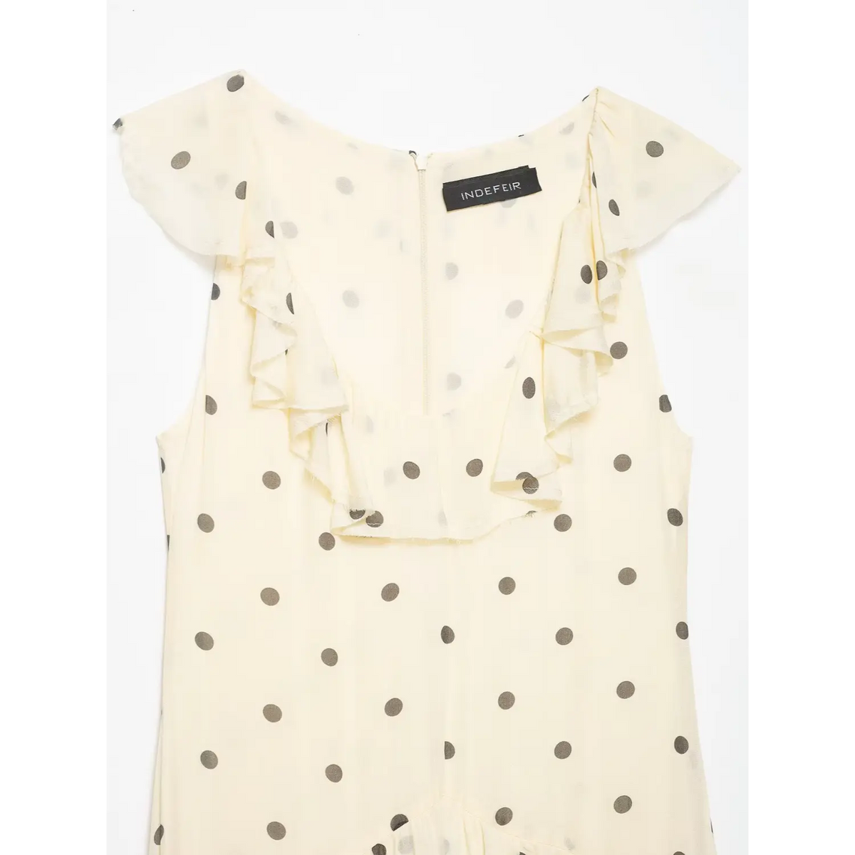 Close‑up of neckline ruffle and back zipper detail