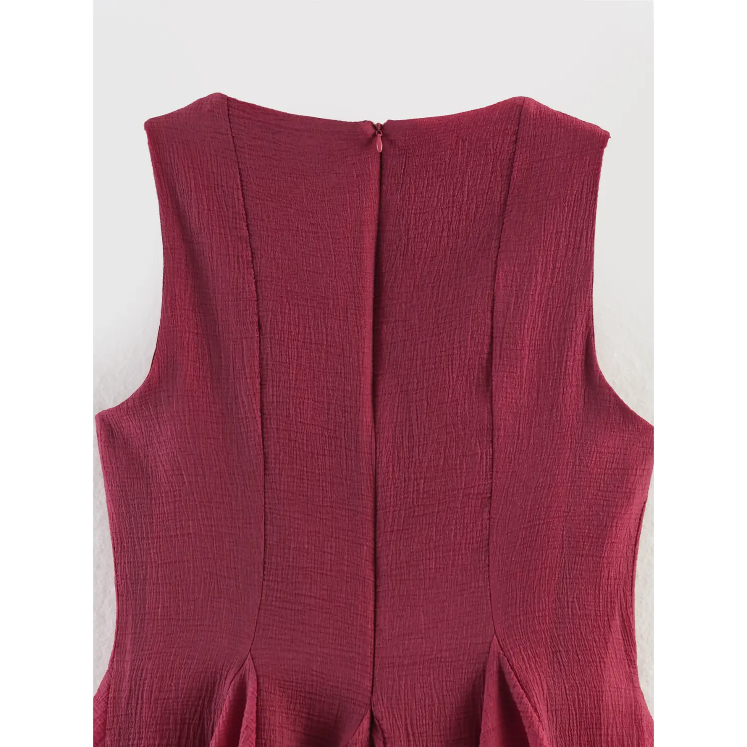Full back torso shot, center back matching invisible zipper, multi vertical contour darts from shoulder to waist, flare skirt cut starting at hip