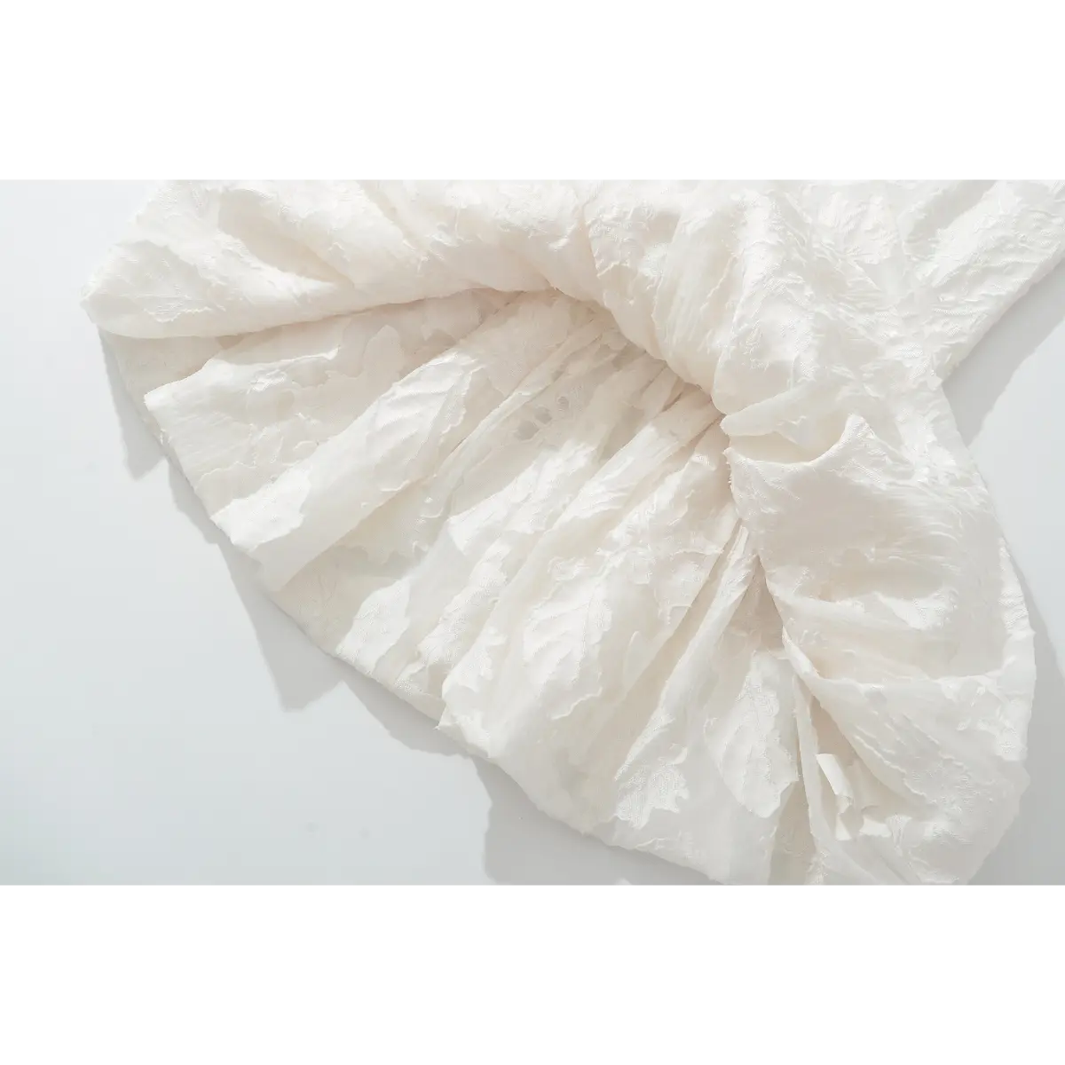 Macro view of textured embossed floral white woven cloth