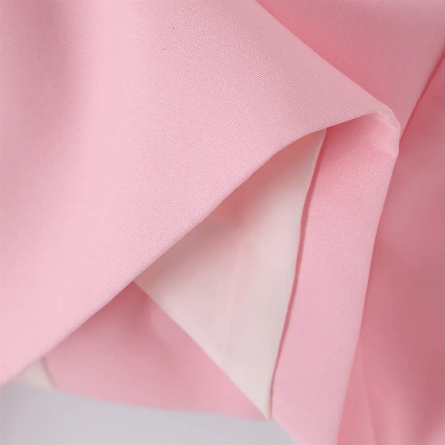 Short cropped hem partial view, inner lining binding, neat hem stitching, lightweight structured blazer drape