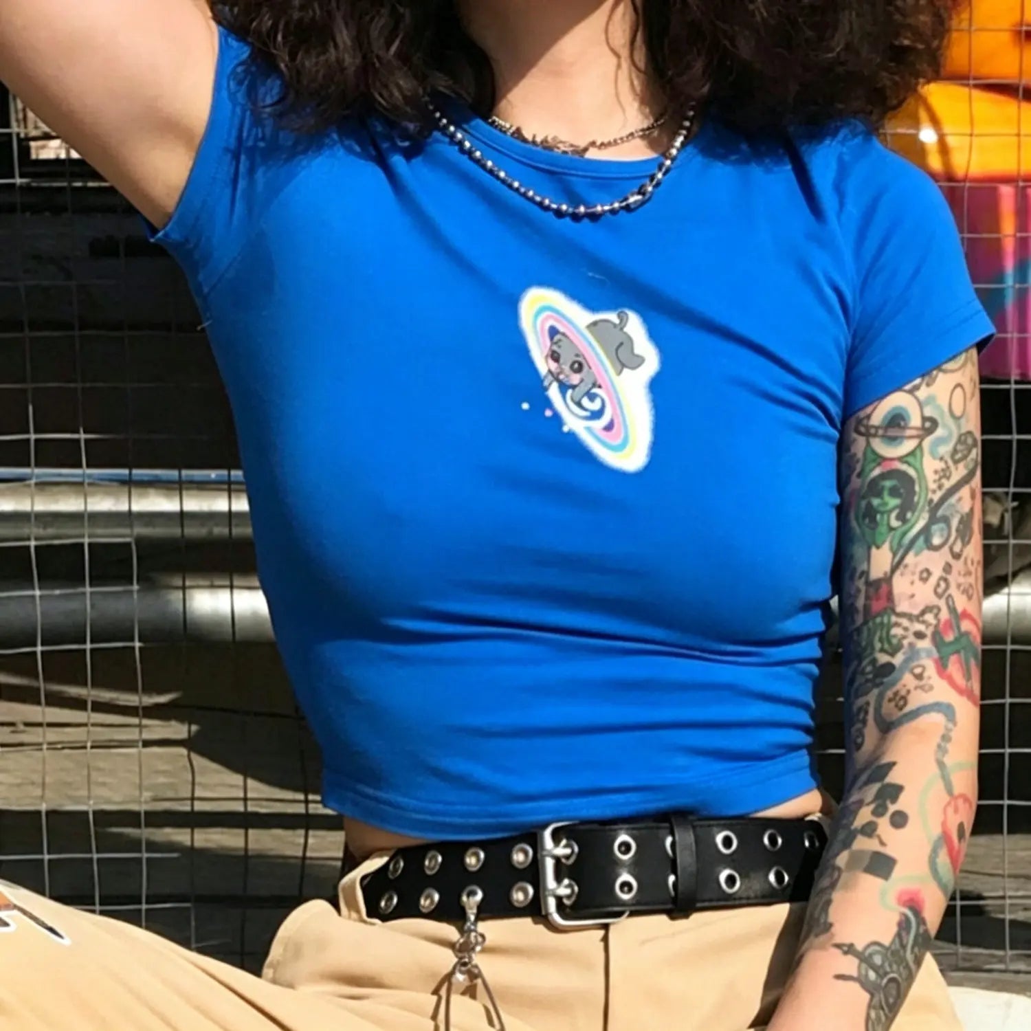 Cropped outdoor model photo blue slim fit crop tee with cartoon cat rainbow planet print