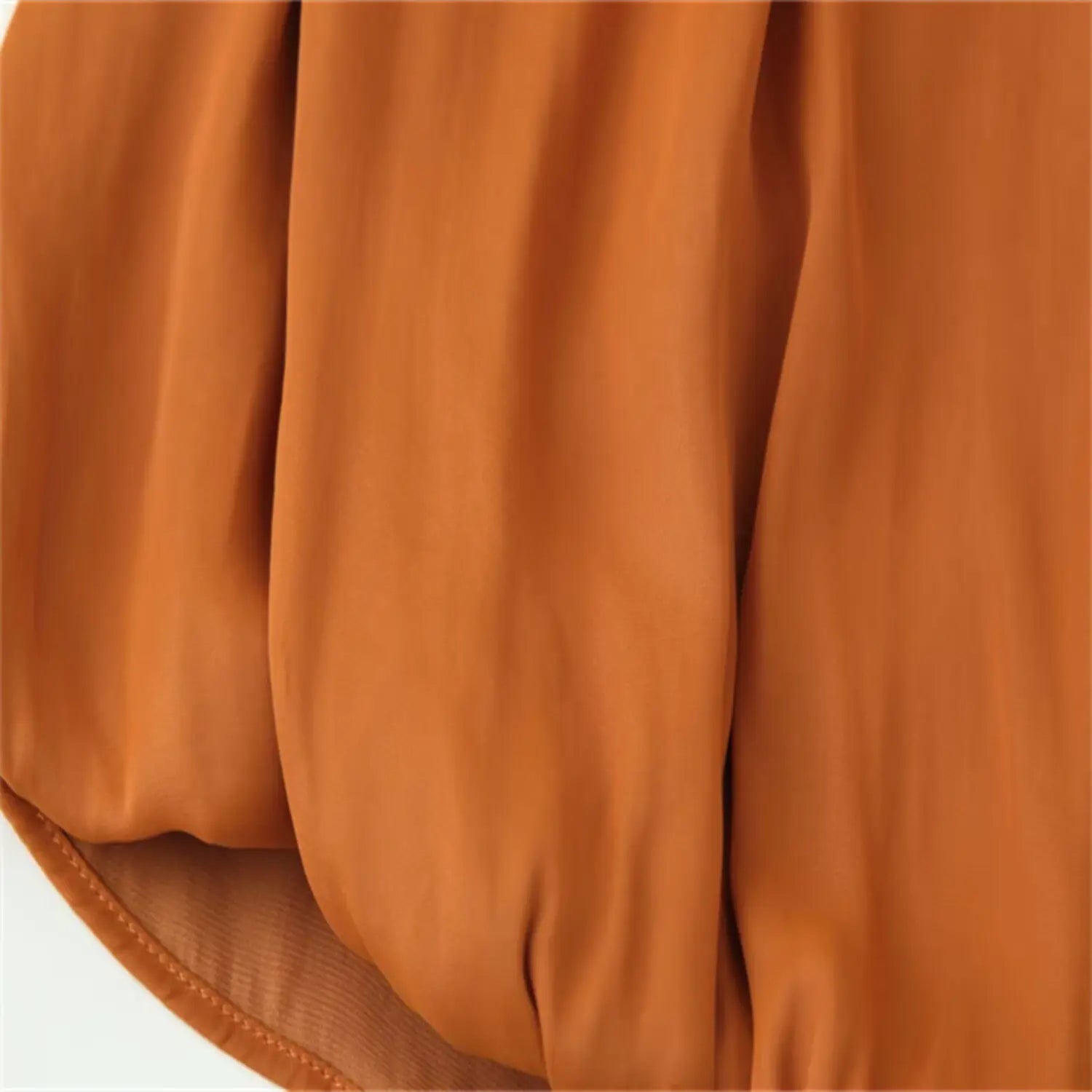 Lower torso shot showing folded drape ending above straight hem lining
