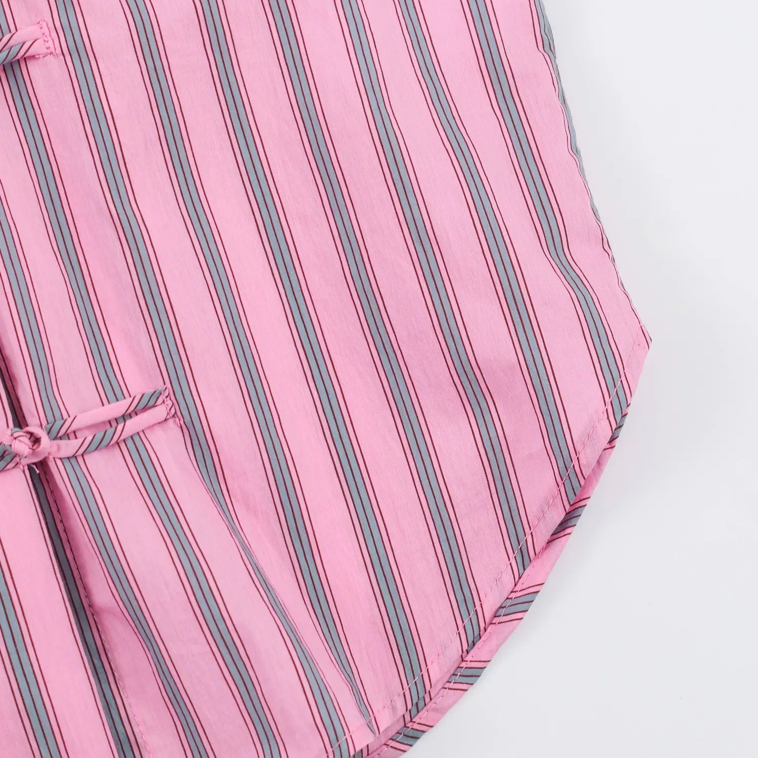 Detail curved hem corner, bias cut stripe layout, finished edge stitching