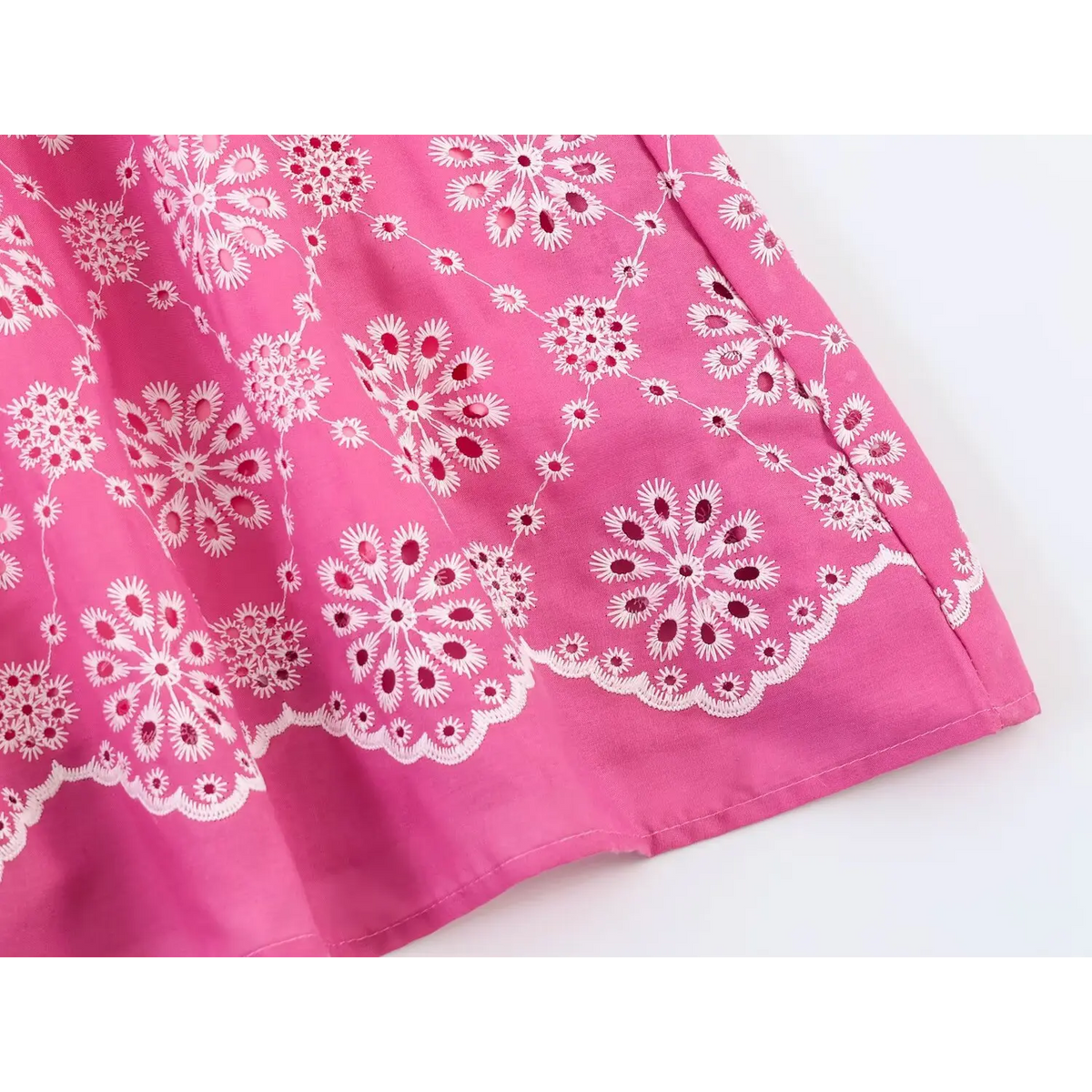 Close-up of scallop edge and daisy embroidery