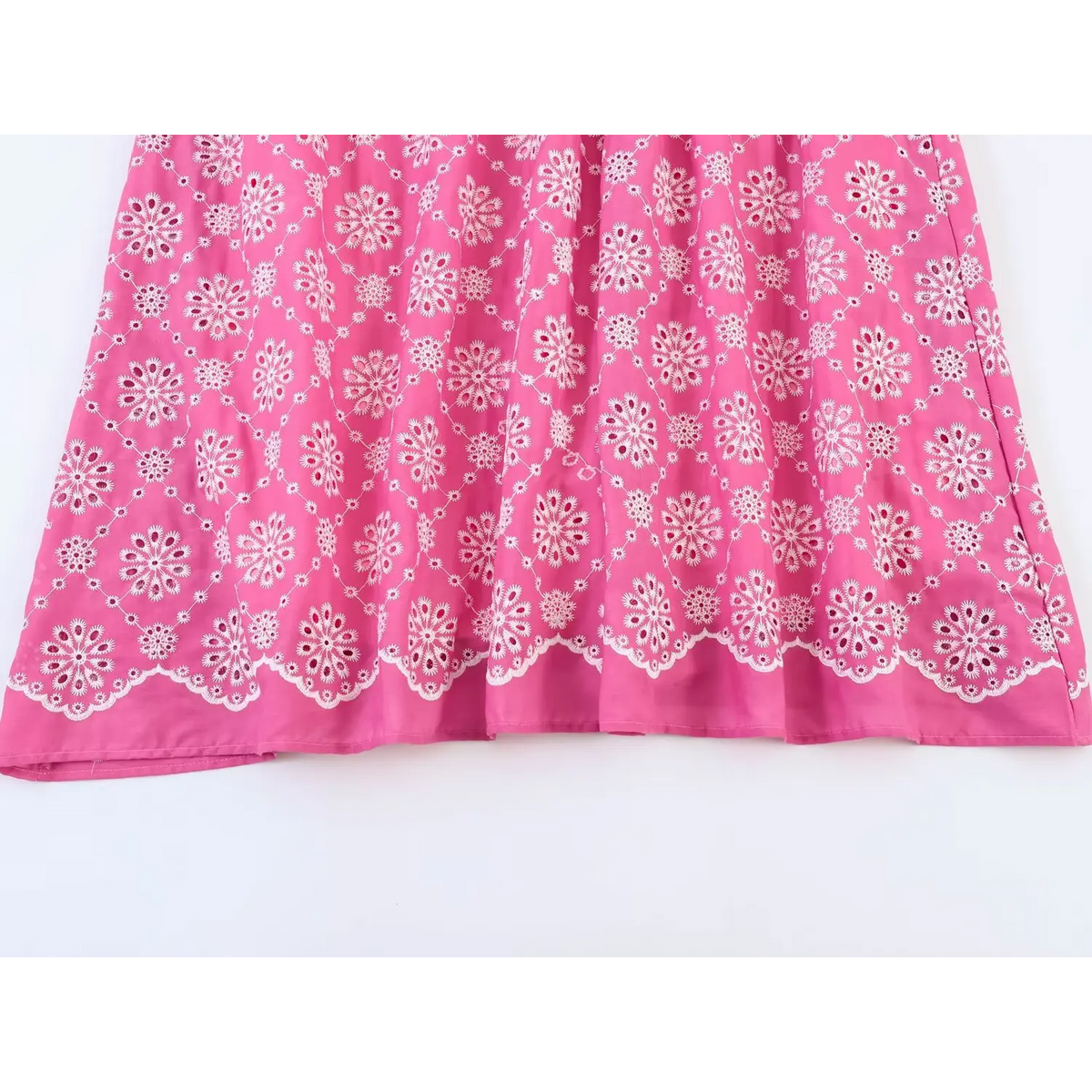 Close-up of scalloped embroidered skirt hem