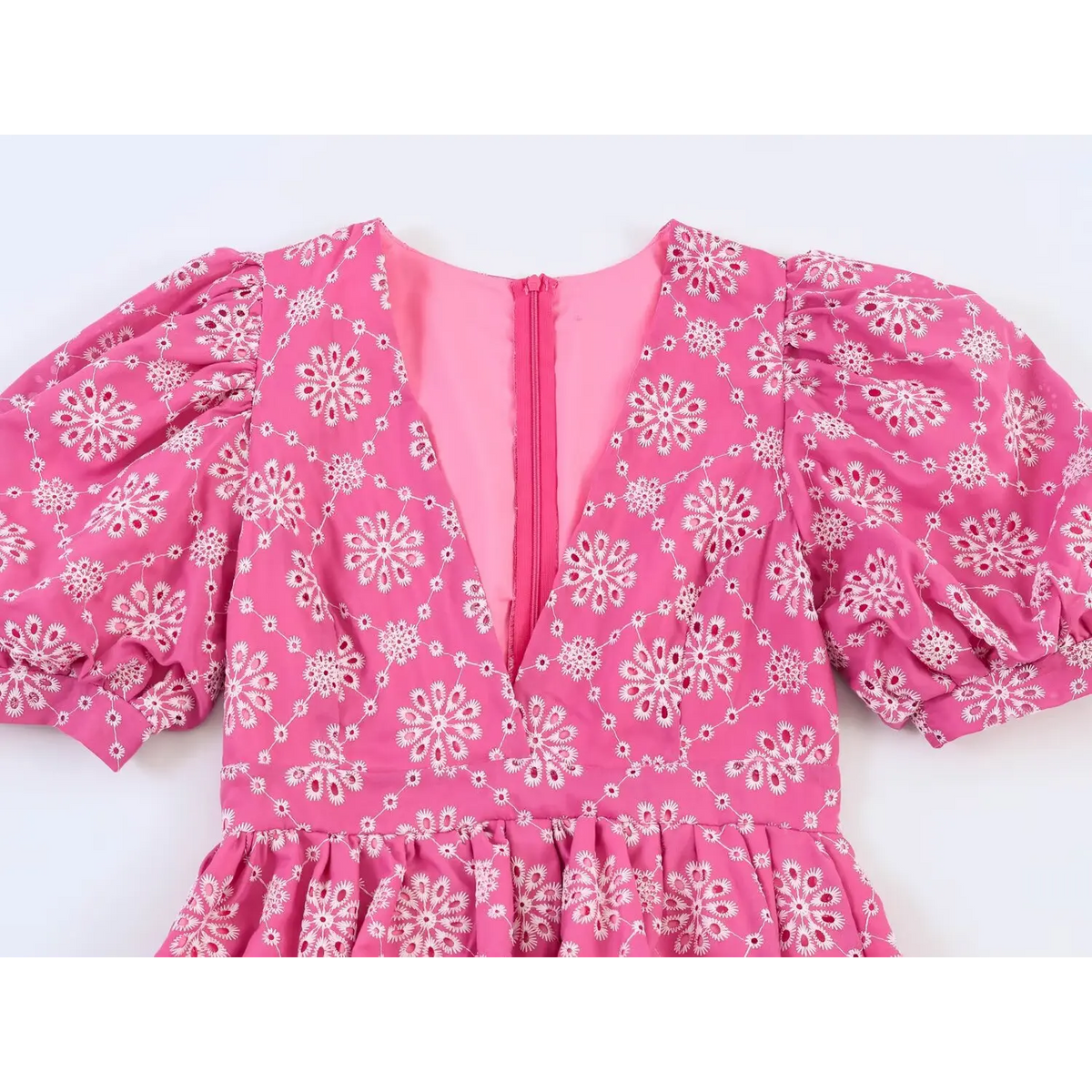 Close-up of deep V neckline and back zipper