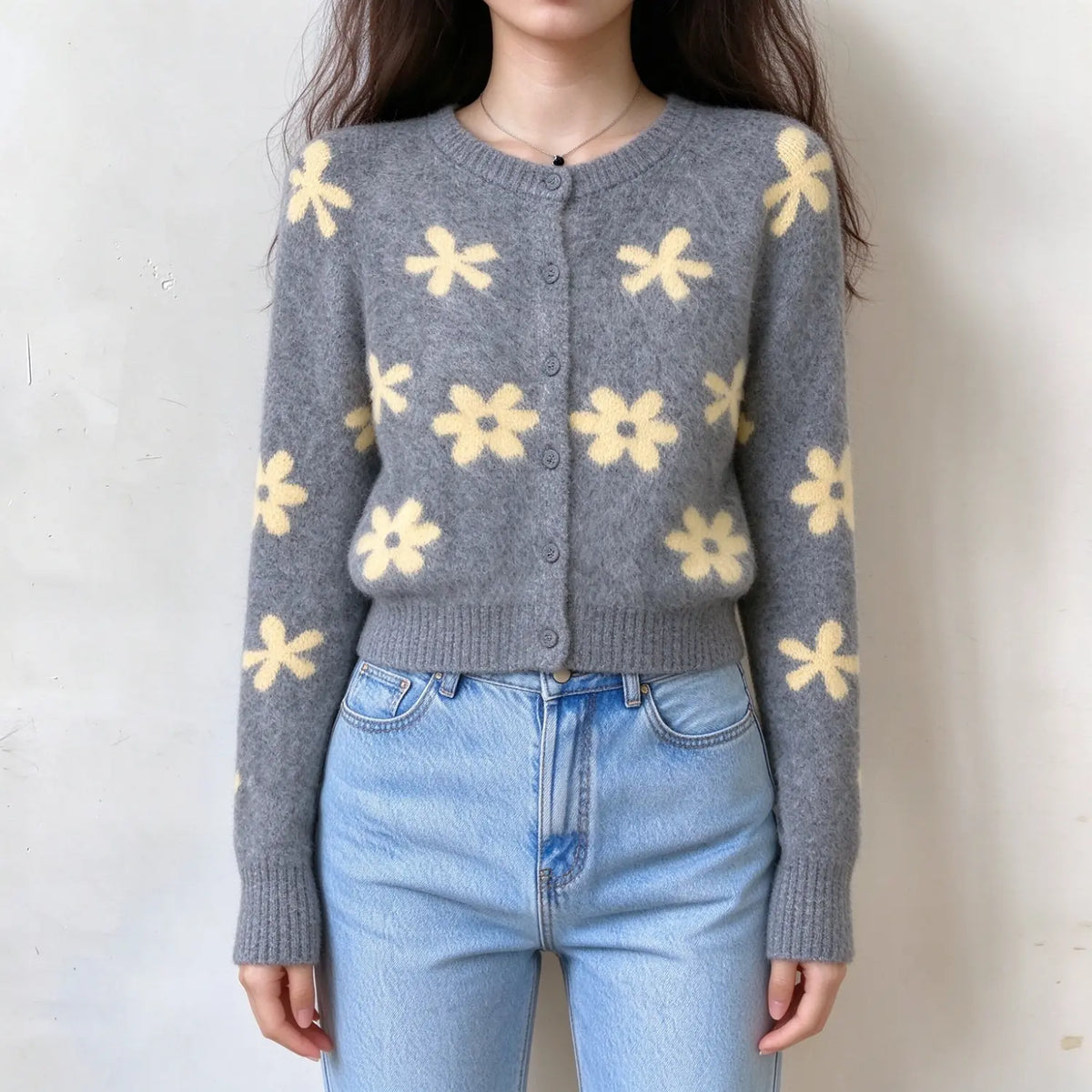 Model wearing grey daisy floral brushed knit cardigan with jeans, front view