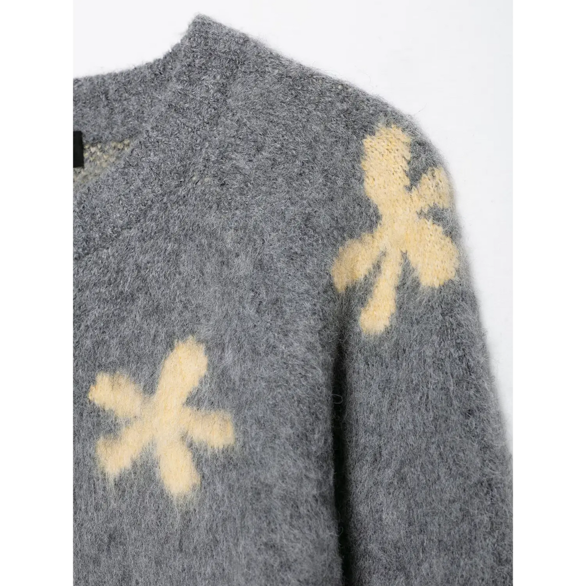 Close-up of daisy flower at shoulder seam