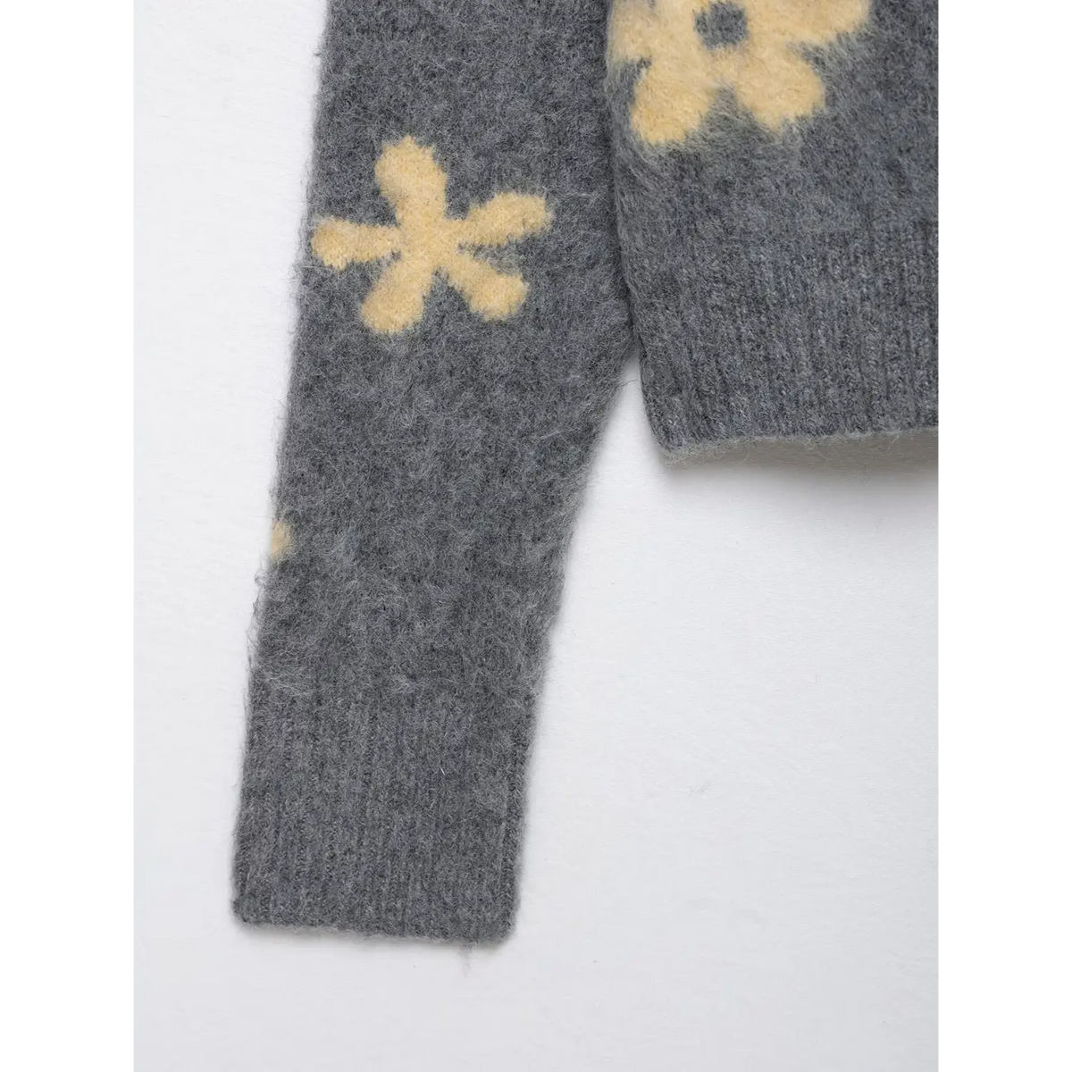 Close-up of sleeve flower pattern and ribbed cuff