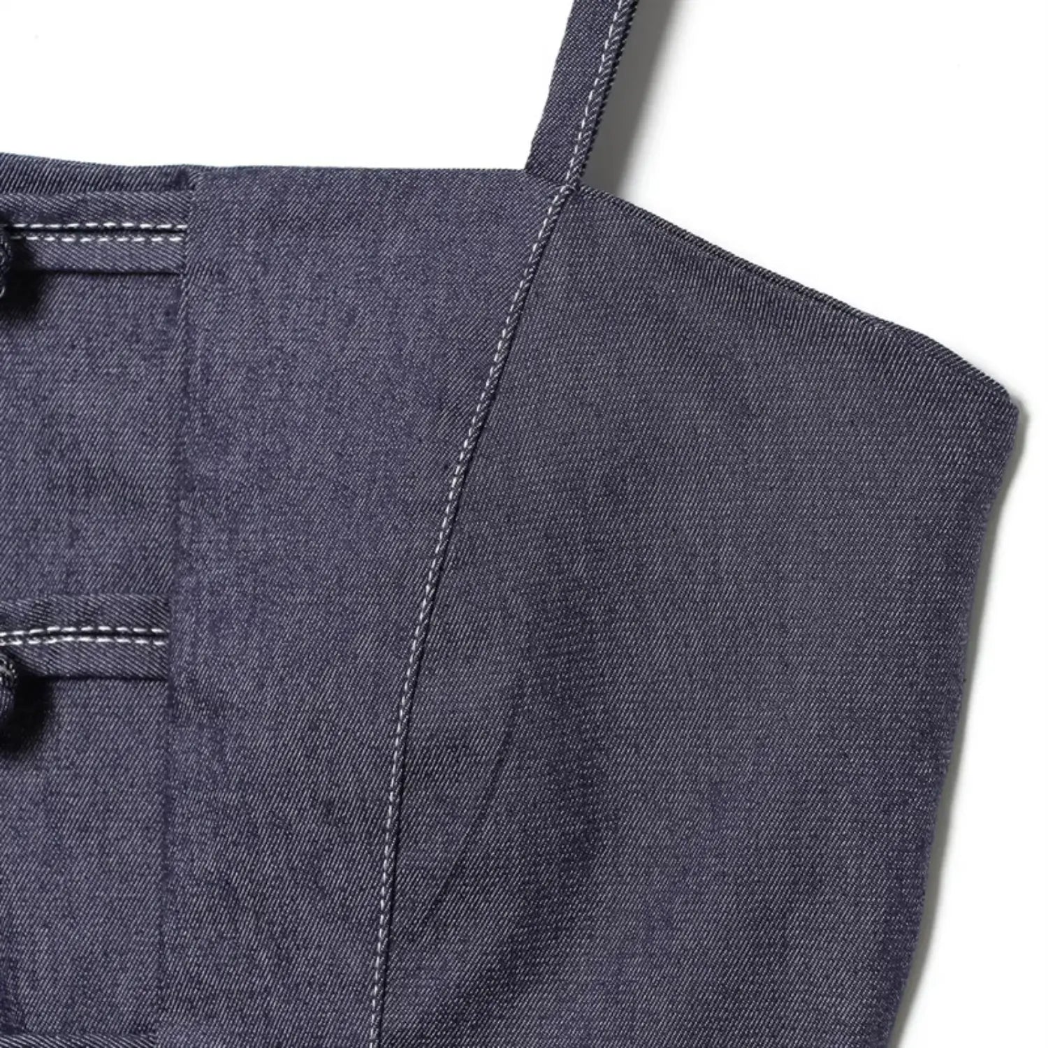 Side bust panel close-up, twill denim weave texture, straight contrast white stitching along vertical tailored seam