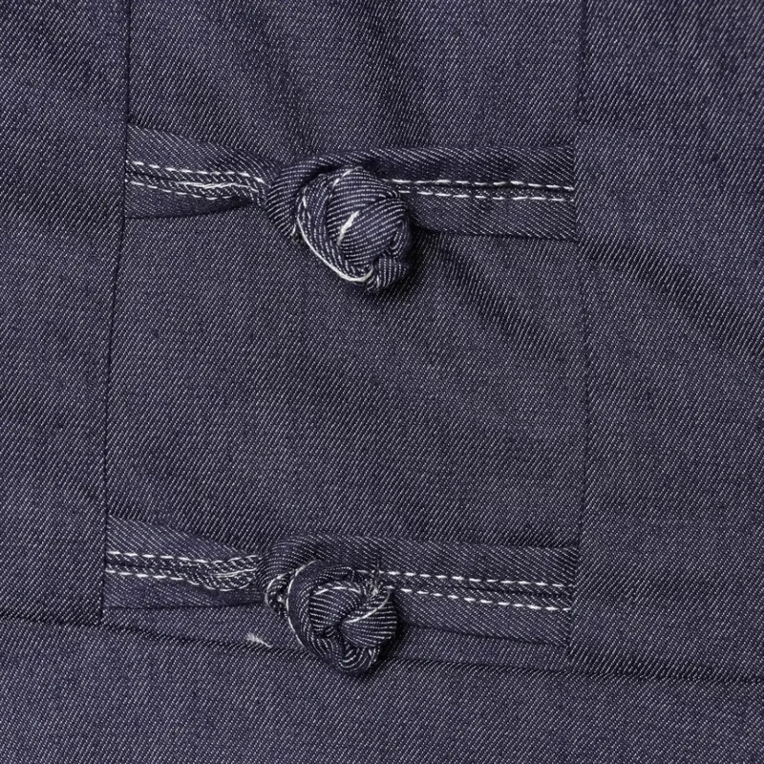 Extreme close-up handmade denim frog knot button, wrapped fabric loop & knot detail, white decorative edge stitching