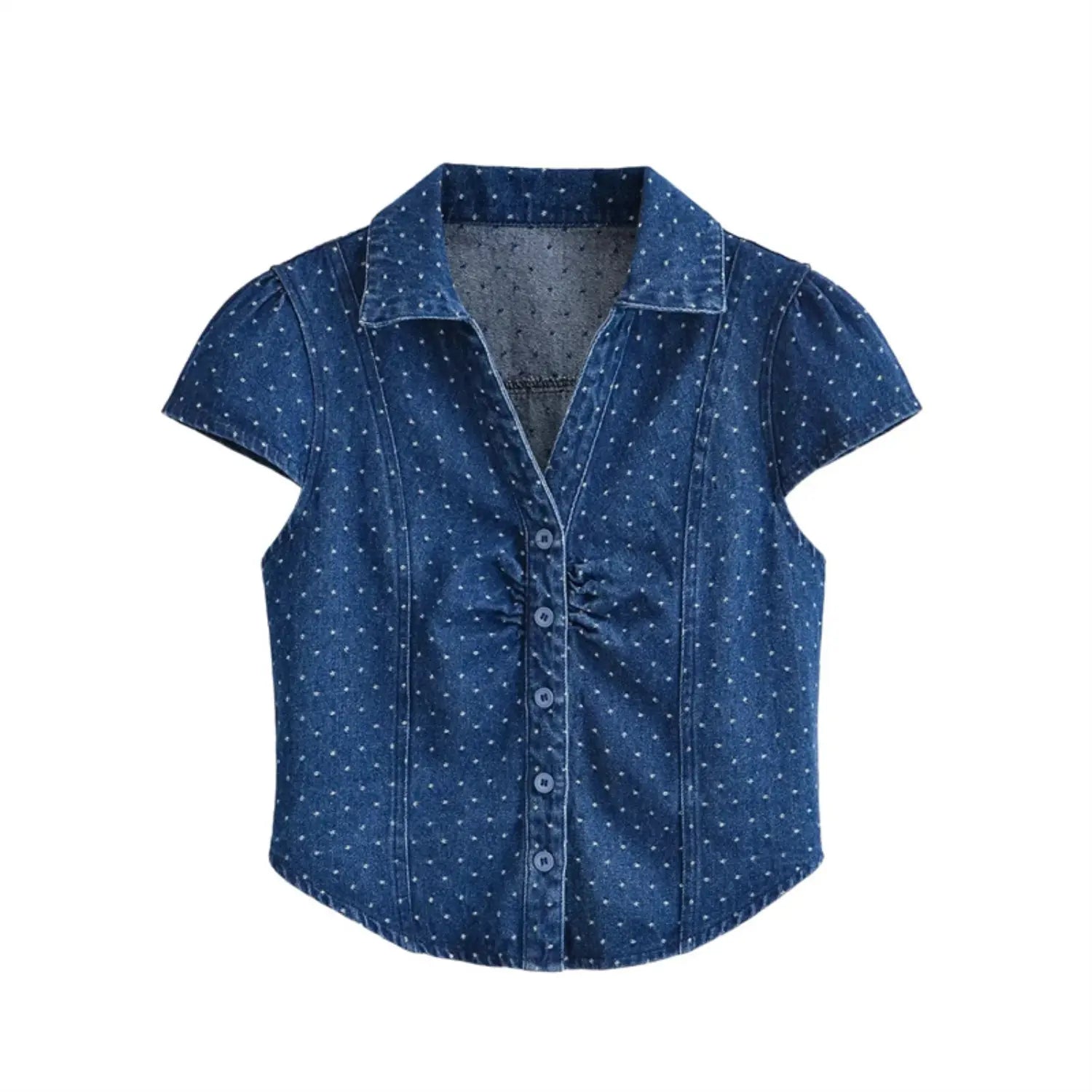 Full front flat lay of dark blue polka dot denim blouse, pointed lapel collar, short cap puff sleeves, front button placket with chest ruched detail, waist shaping seams, curved cropped hem, soft washed denim fabric