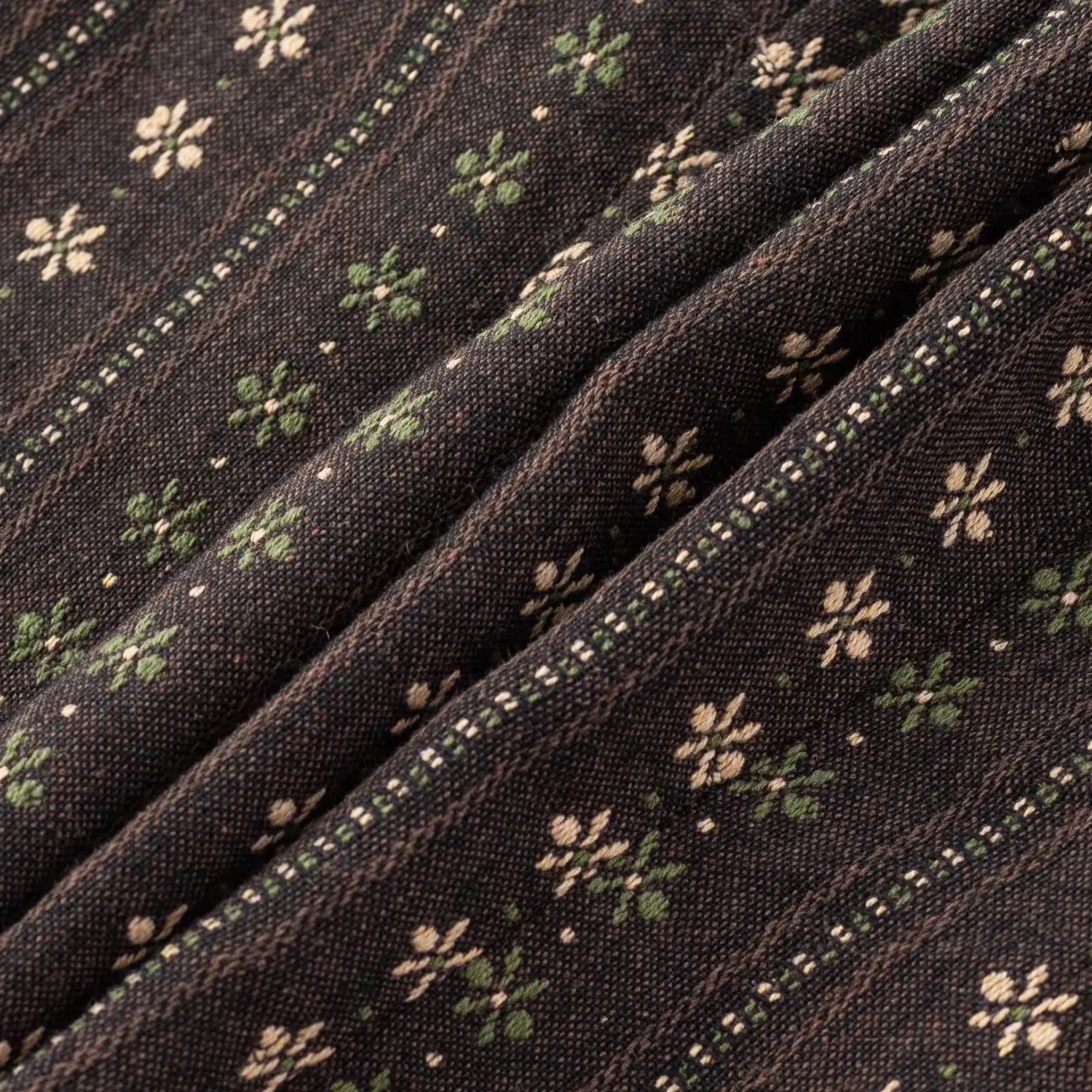 Dark brown vintage floral woven fabric macro shot, vertical stripe and off-white tiny flower print texture flat lay