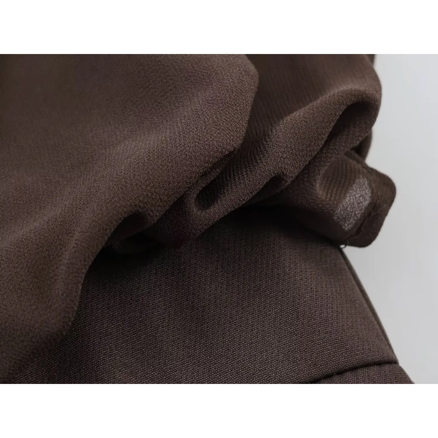 Side torso joint shot, voluminous bubble blouson chiffon overlay spliced onto solid waistband, contrast between sheer chiffon and thick suiting skirt fabric