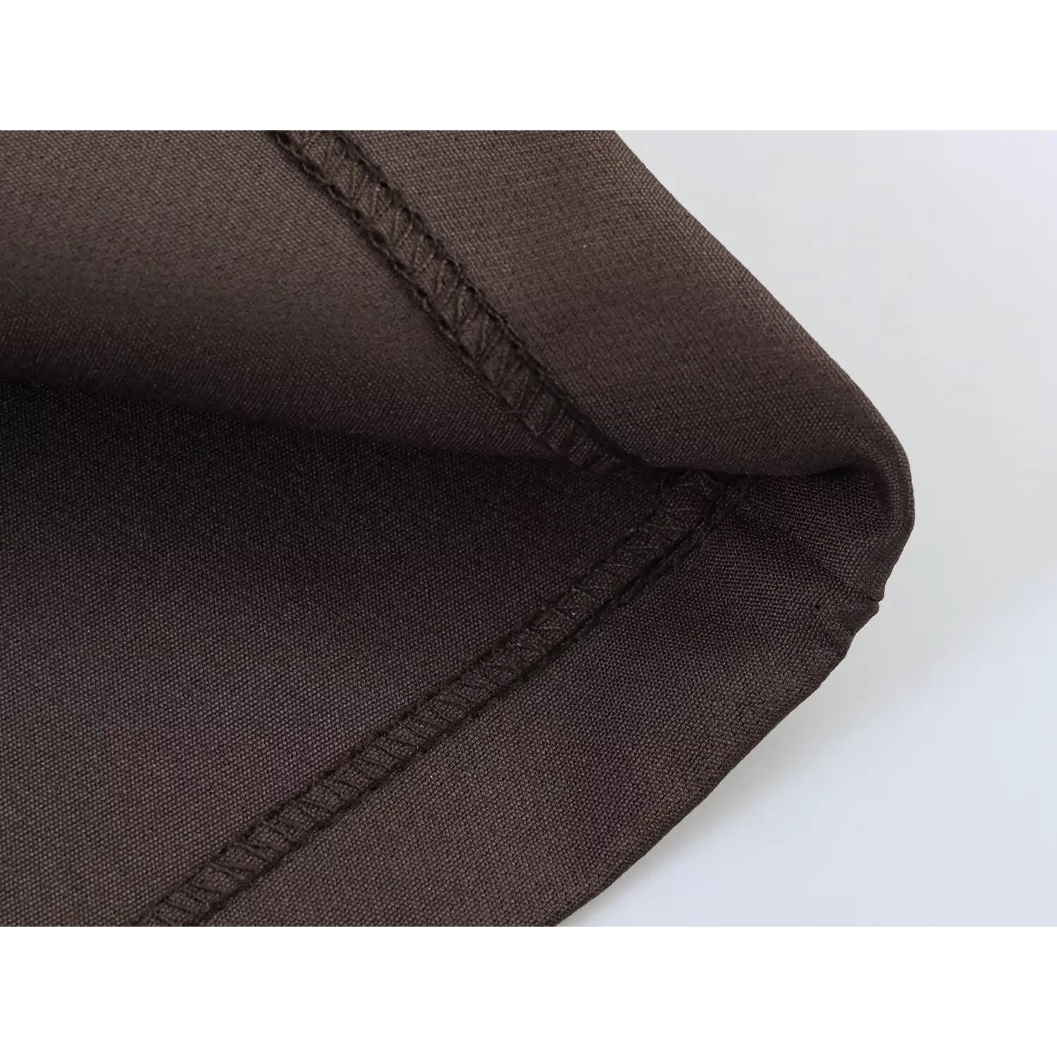 Macro shot of skirt hem, two parallel neat stitching lines, thick matte suit fabric, clean folded hem finish