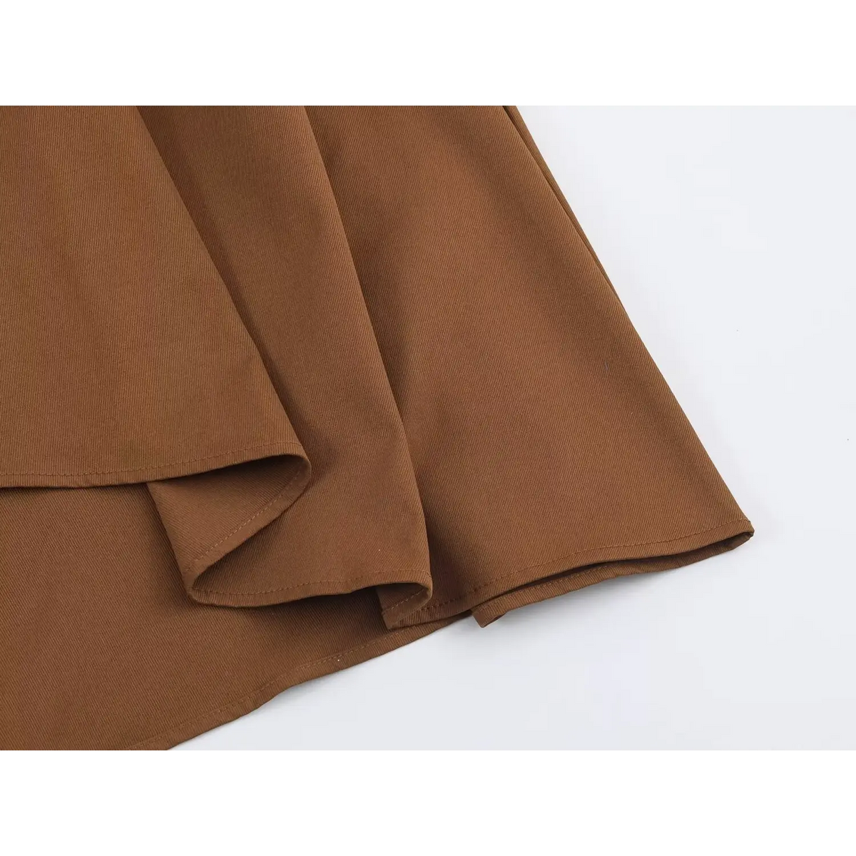 Close-up of folded brown twill fabric with clean stitching