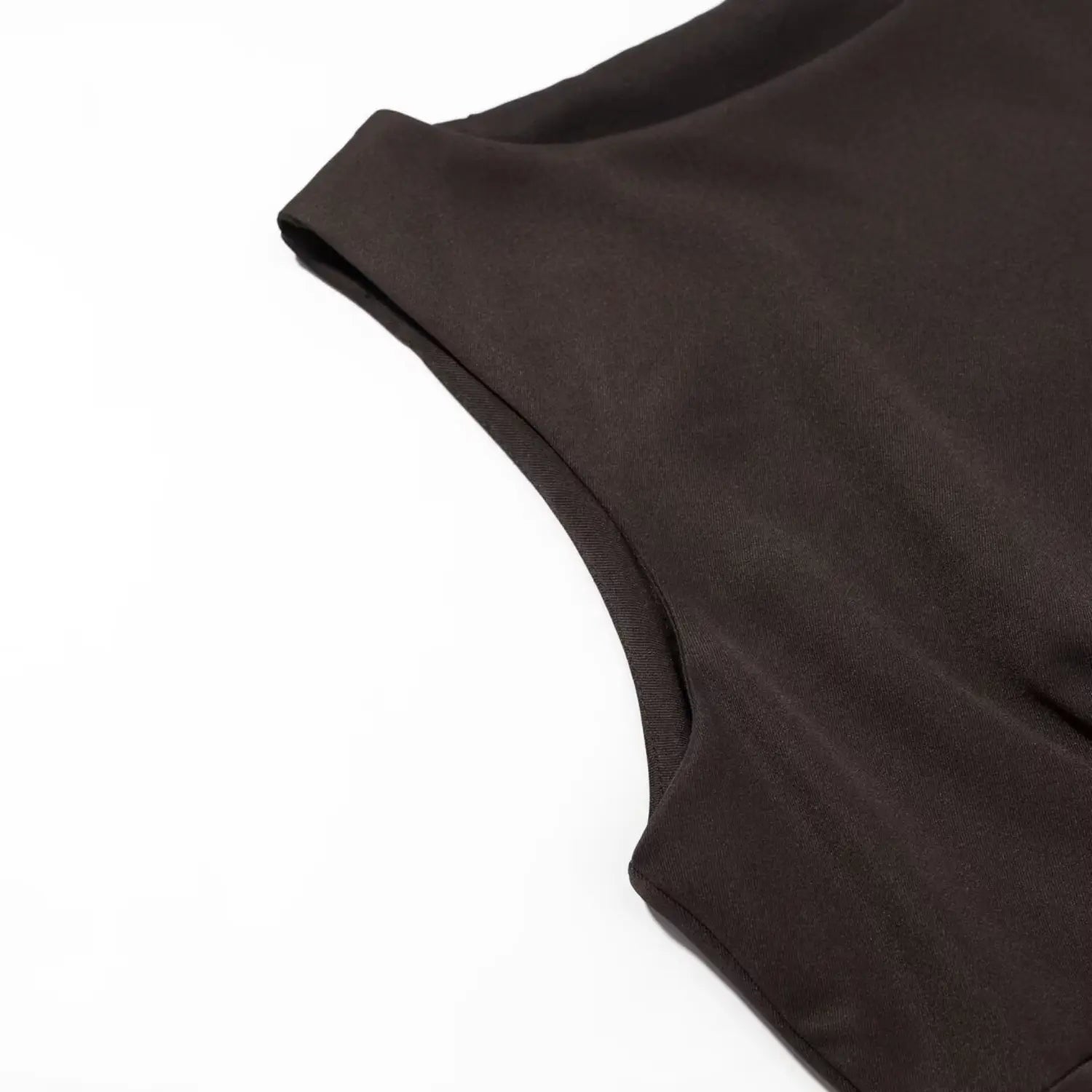Macro shot of armhole seam and fine fabric texture of dark brown sleeveless mini dress