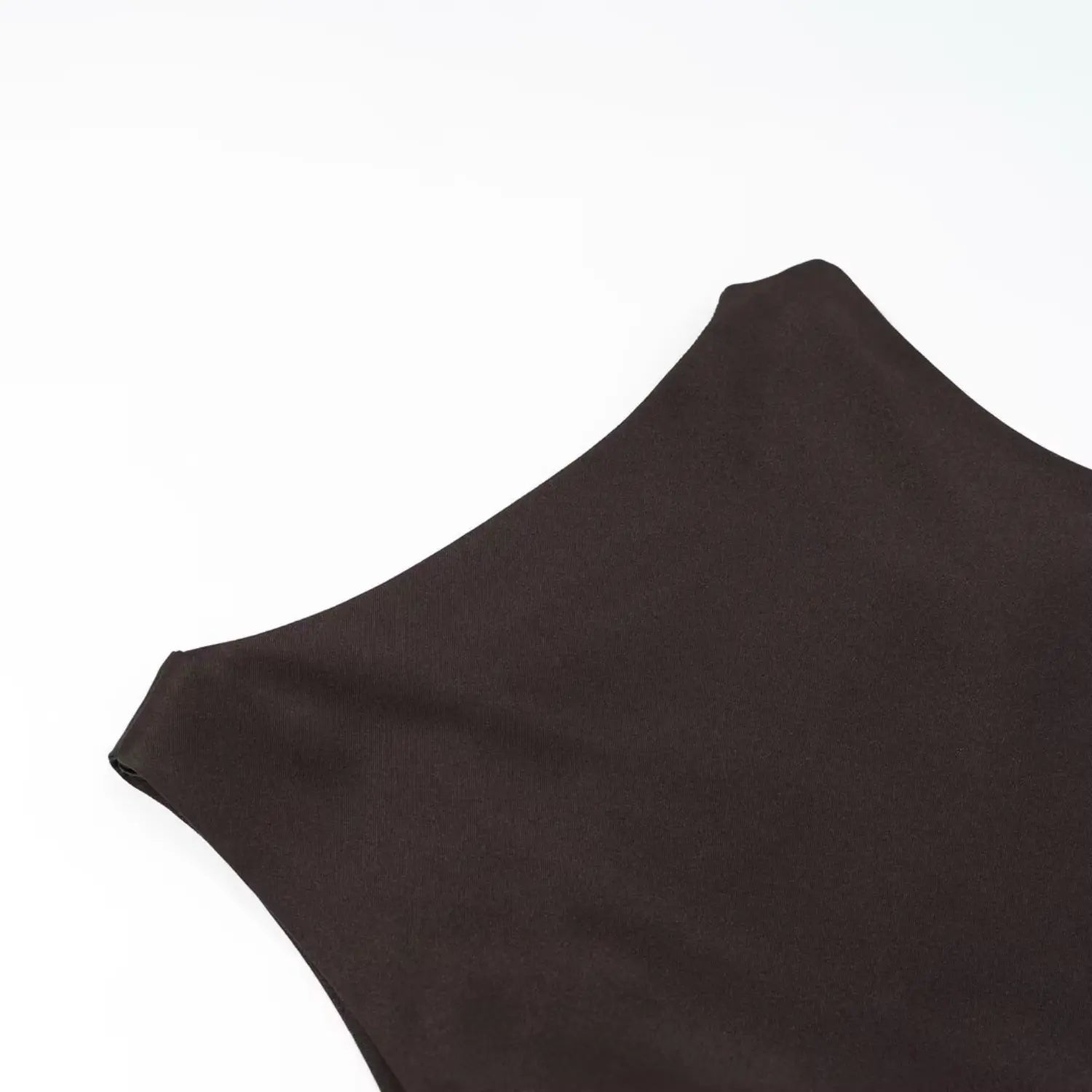 Close‑up view of soft matte fabric texture of dark brown sleeveless ruffle dress