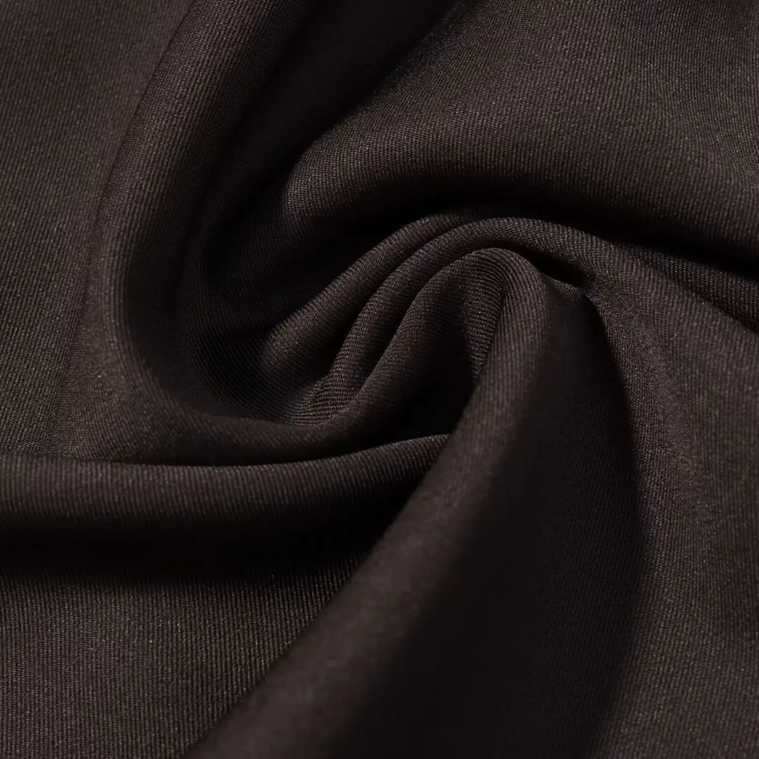 Close‑up wrinkled matte fabric texture of dark brown mini dress material