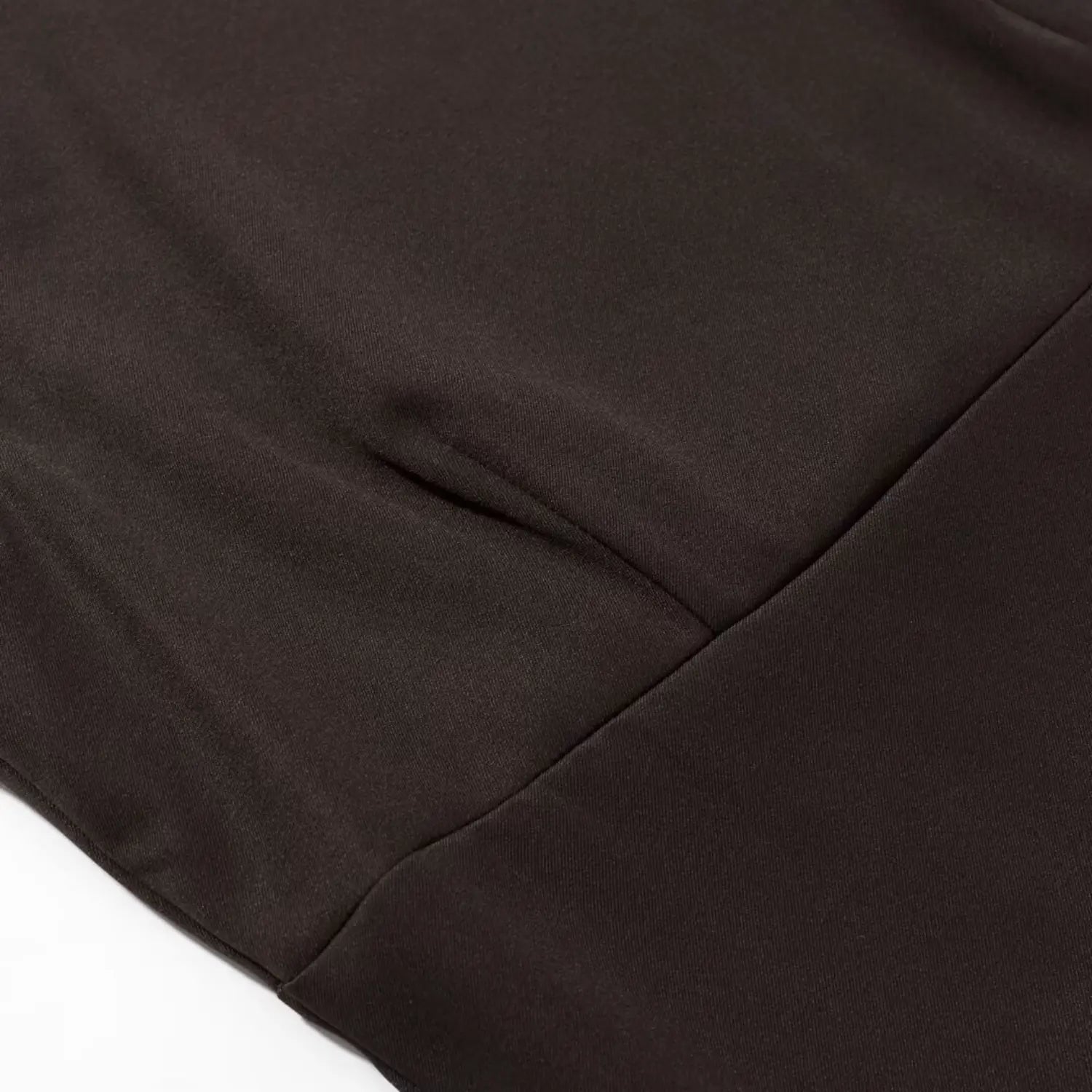 Close‑up view of bodice seam stitching detail on dark brown sleeveless mini dress