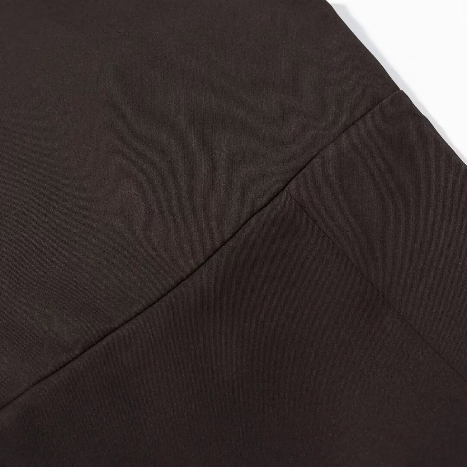 Macro shot of waist horizontal seam construction on dark brown ruffle hem mini dress