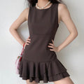 Model front view wearing dark brown sleeveless round neck layered ruffle hem mini dress