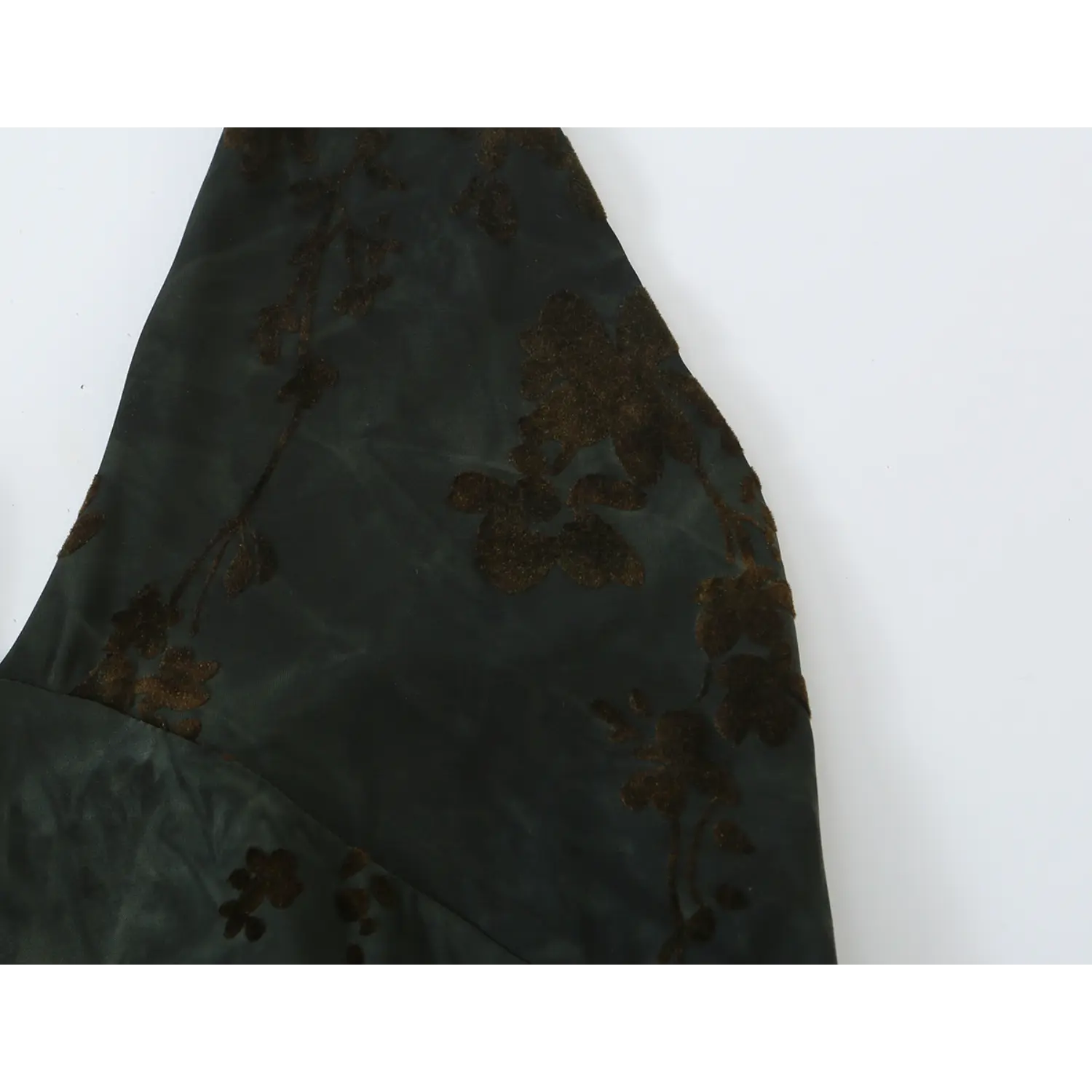Macro detail of dark green base with brown floral print on sheer lightweight chiffon fabric