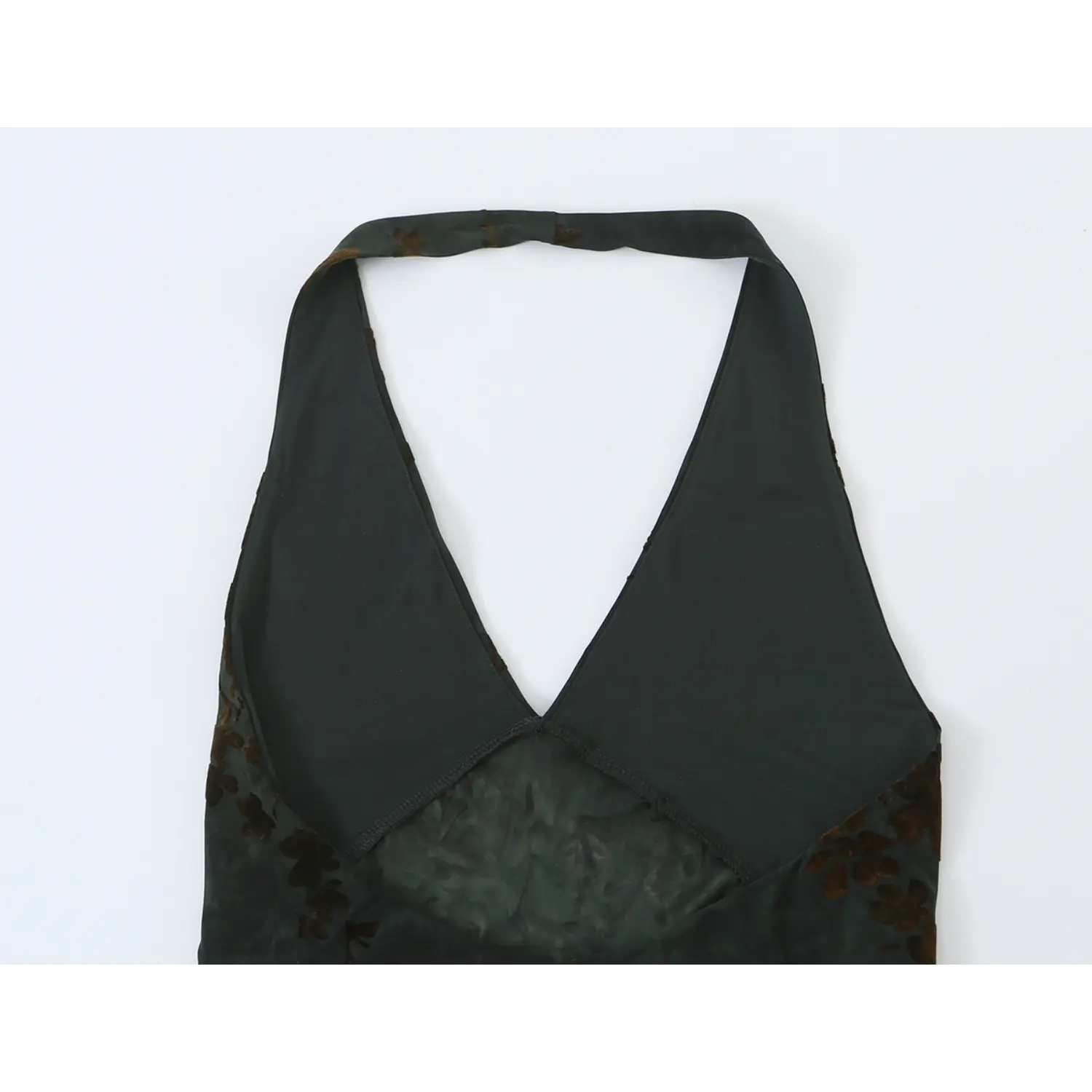 Close‑up of halter strap and open back neckline on dark green floral maxi dress